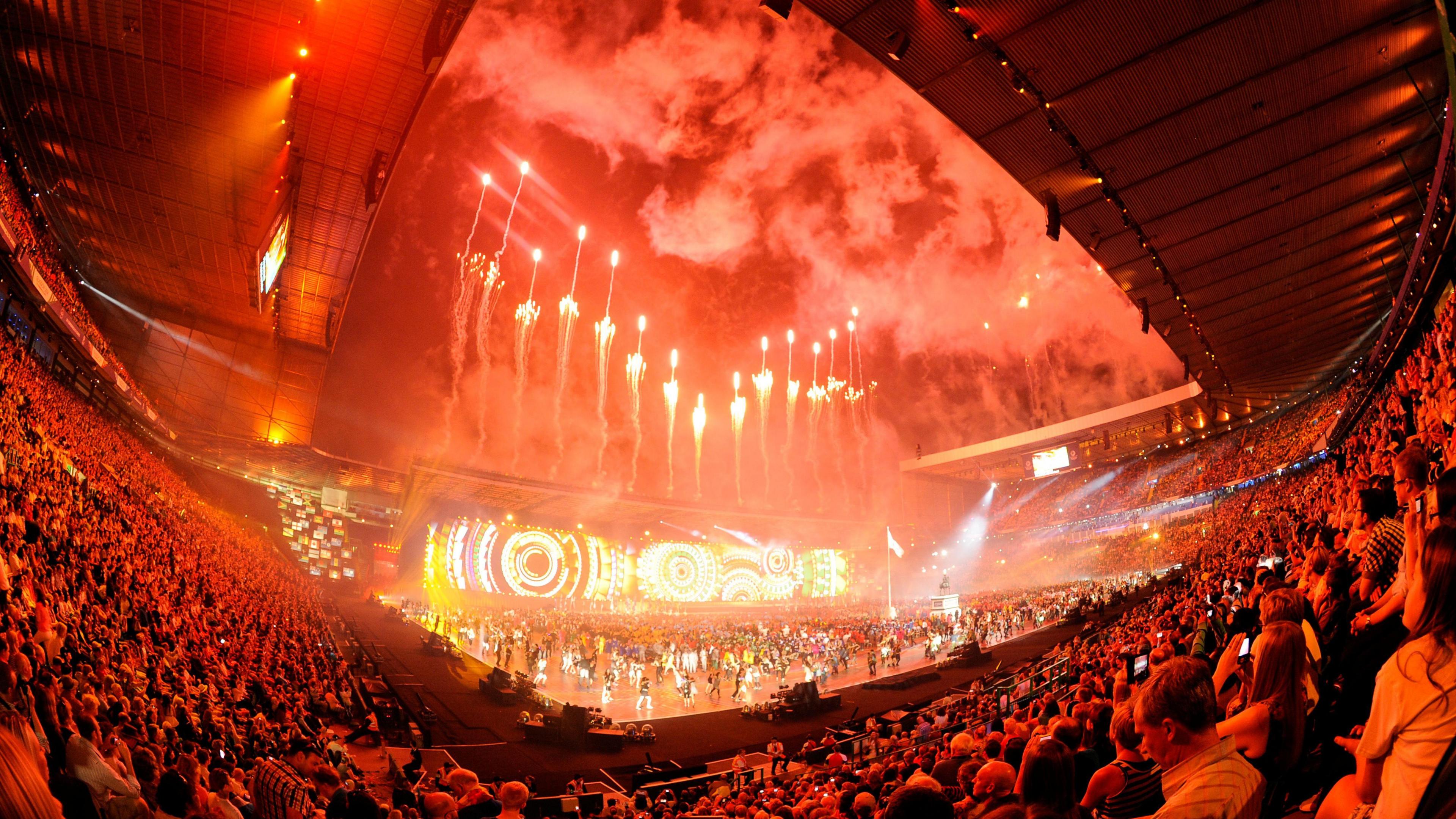 Red fireworks illuminate the night sky over Celtic park during the 2014 Commonwealth Games opening ceremony.