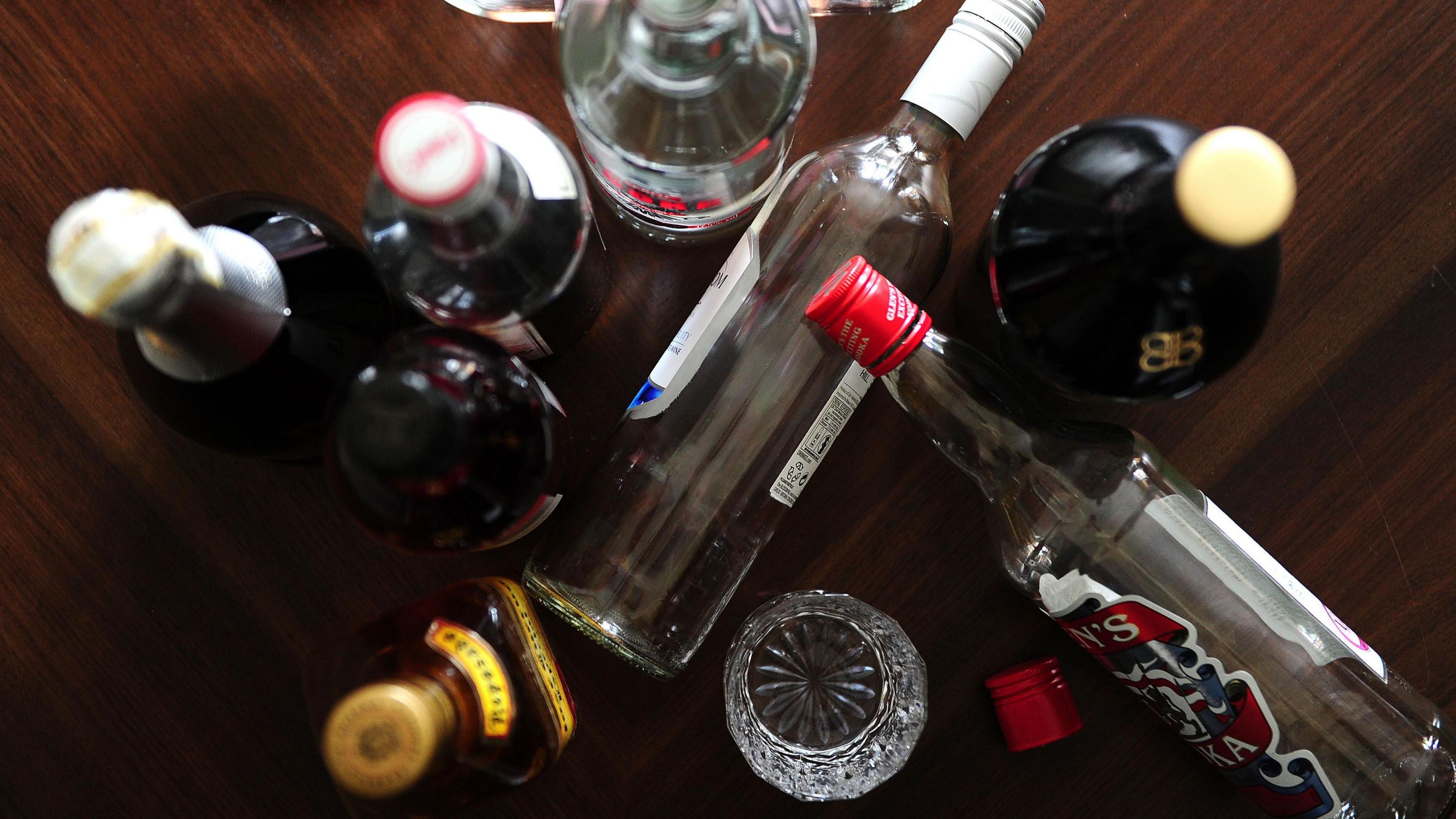 Image of empty bottles of alcohol sprawled on a table