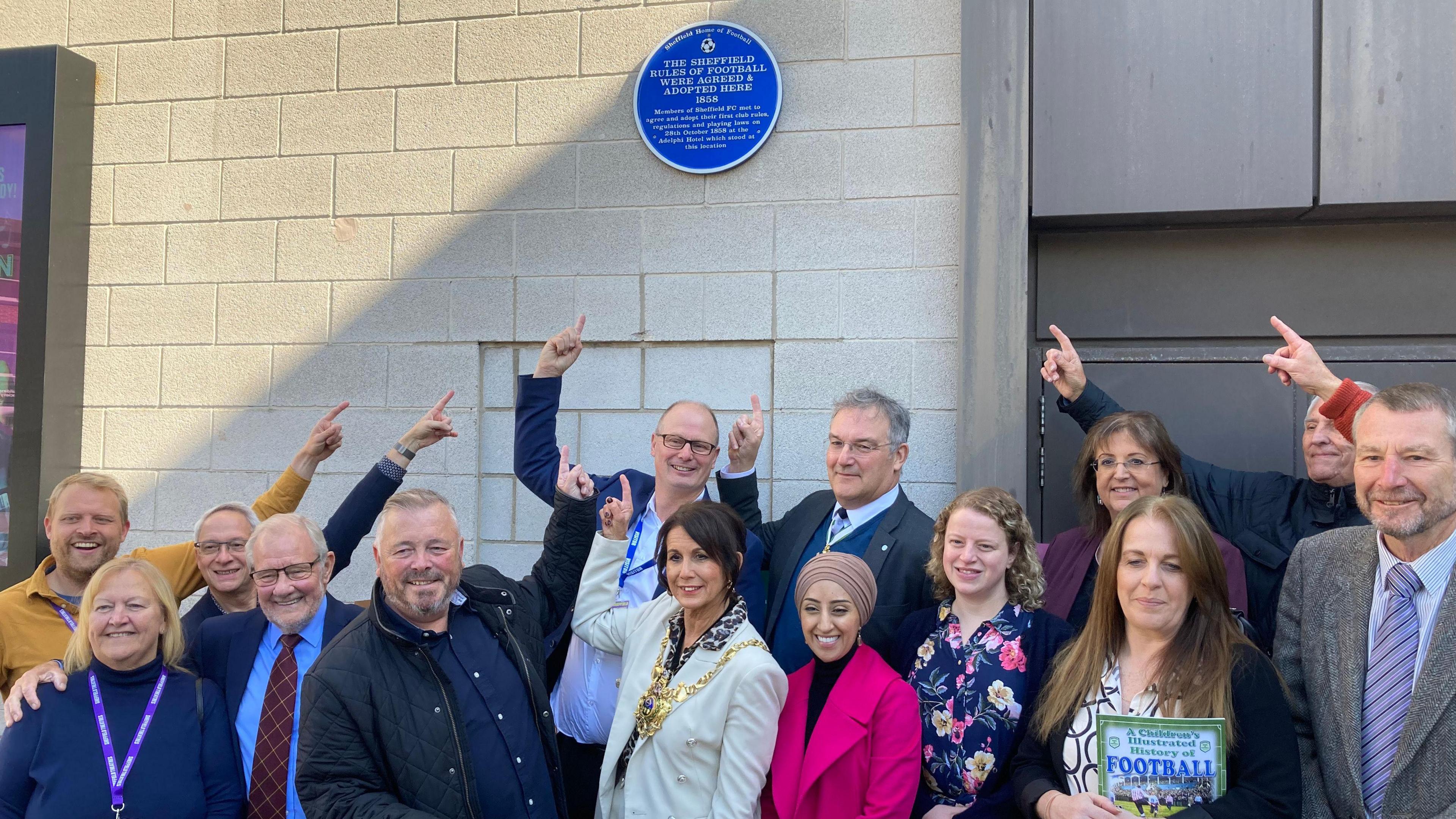 Campaigners from the Sheffield Home of Football group pose for a photo with the blue plaque