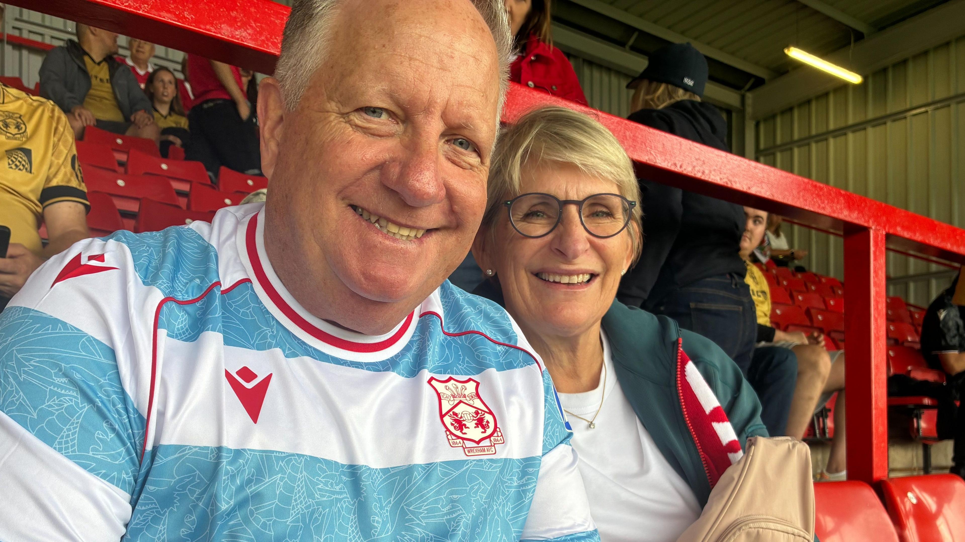 Ian Healy and his wife Helen (right) watch Wrexham in a home game