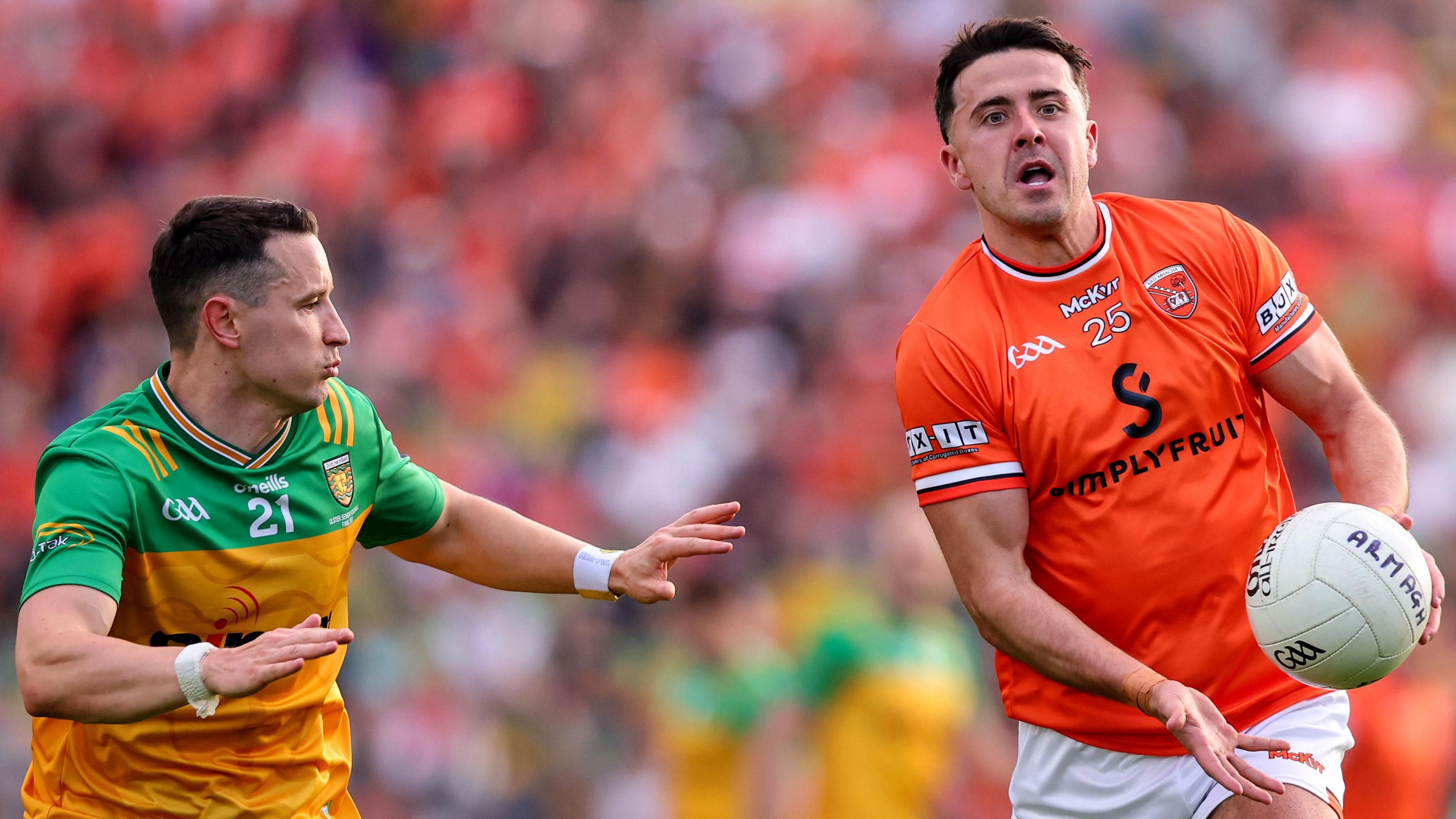 Armagh substitute Stefan Campbell attempts to hand pass the ball away as Donegal's Eoin McHugh is about to challenge him