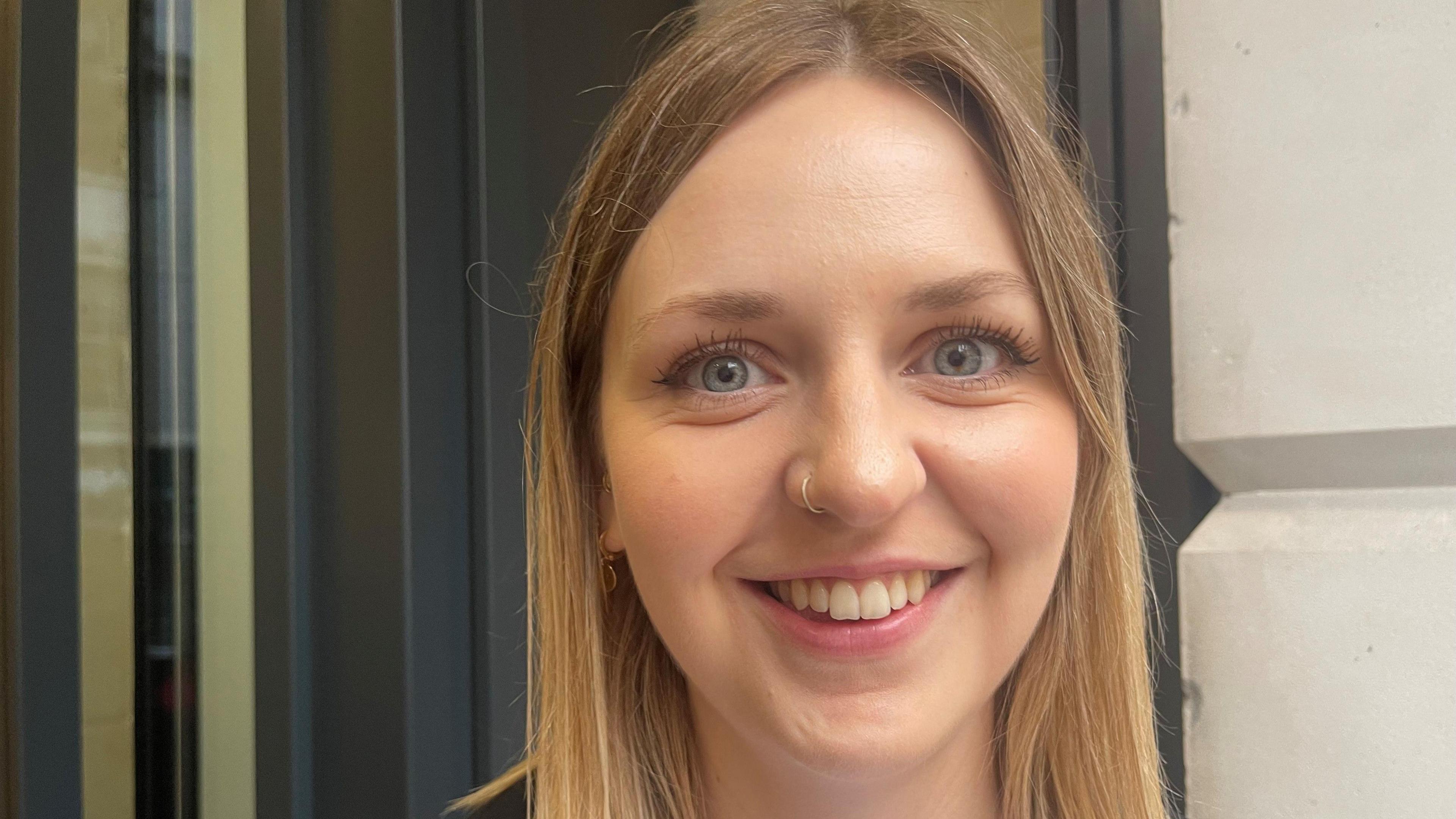 A young blond woman smiles