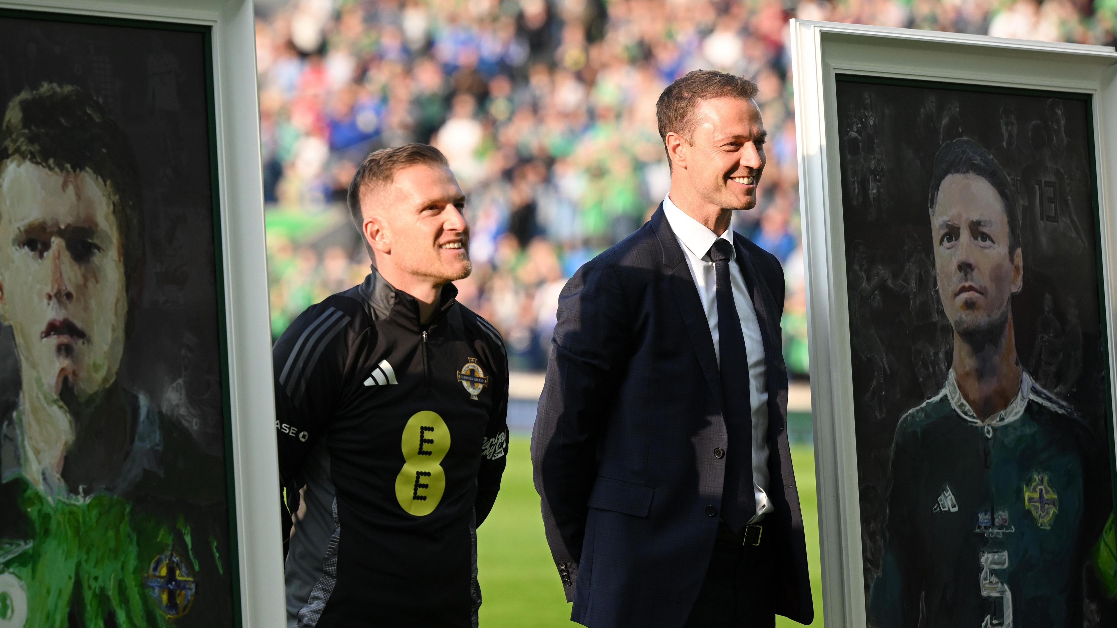Steven Davis and Jonny Evans receive portraits of themselves before Tuesday's Iceland game