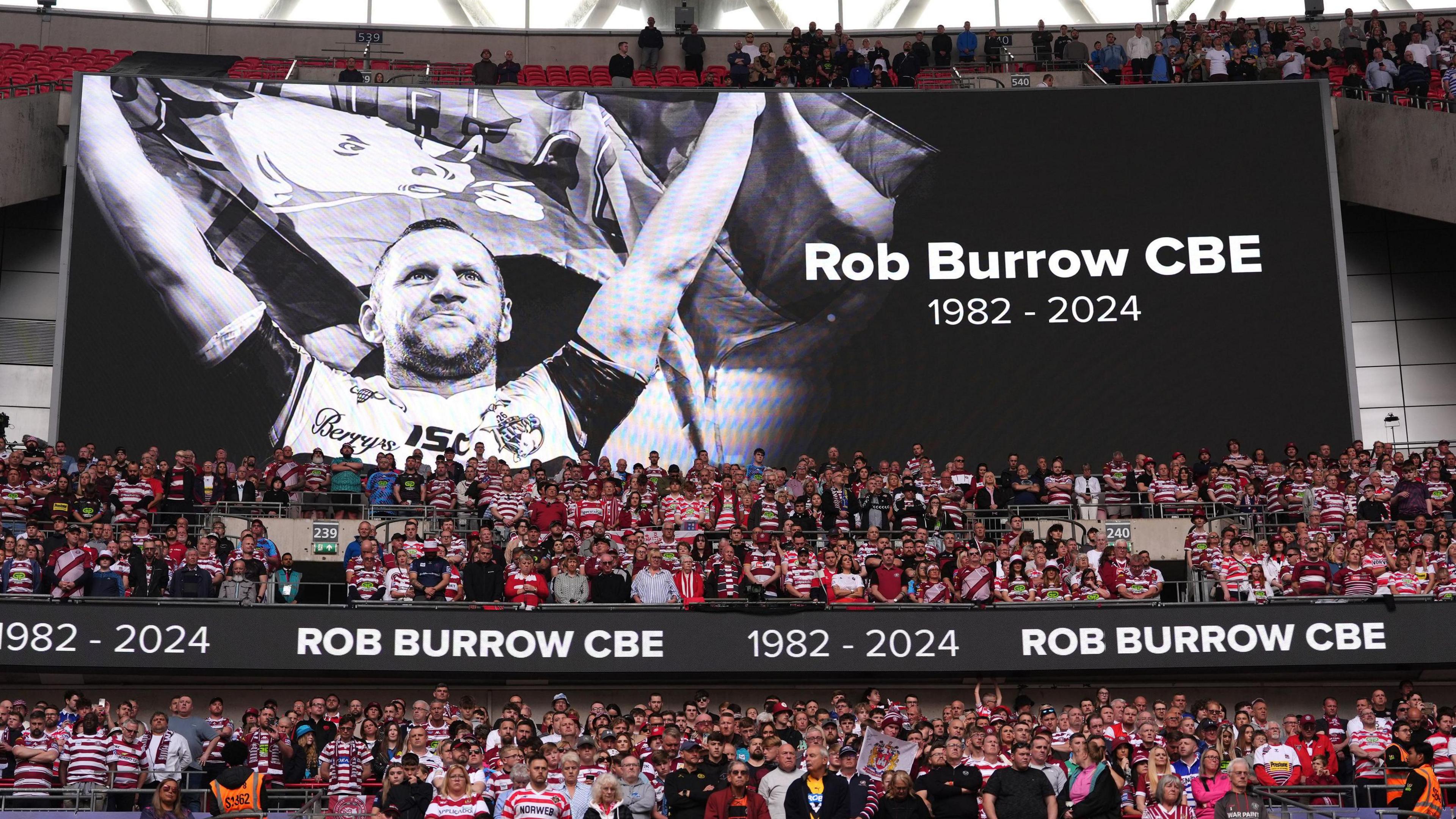 The large stadium screen showing a tribute to former Leeds Rhinos player Rob Burrow during the Betfred Challenge Cup final at Wembley Stadium, London.