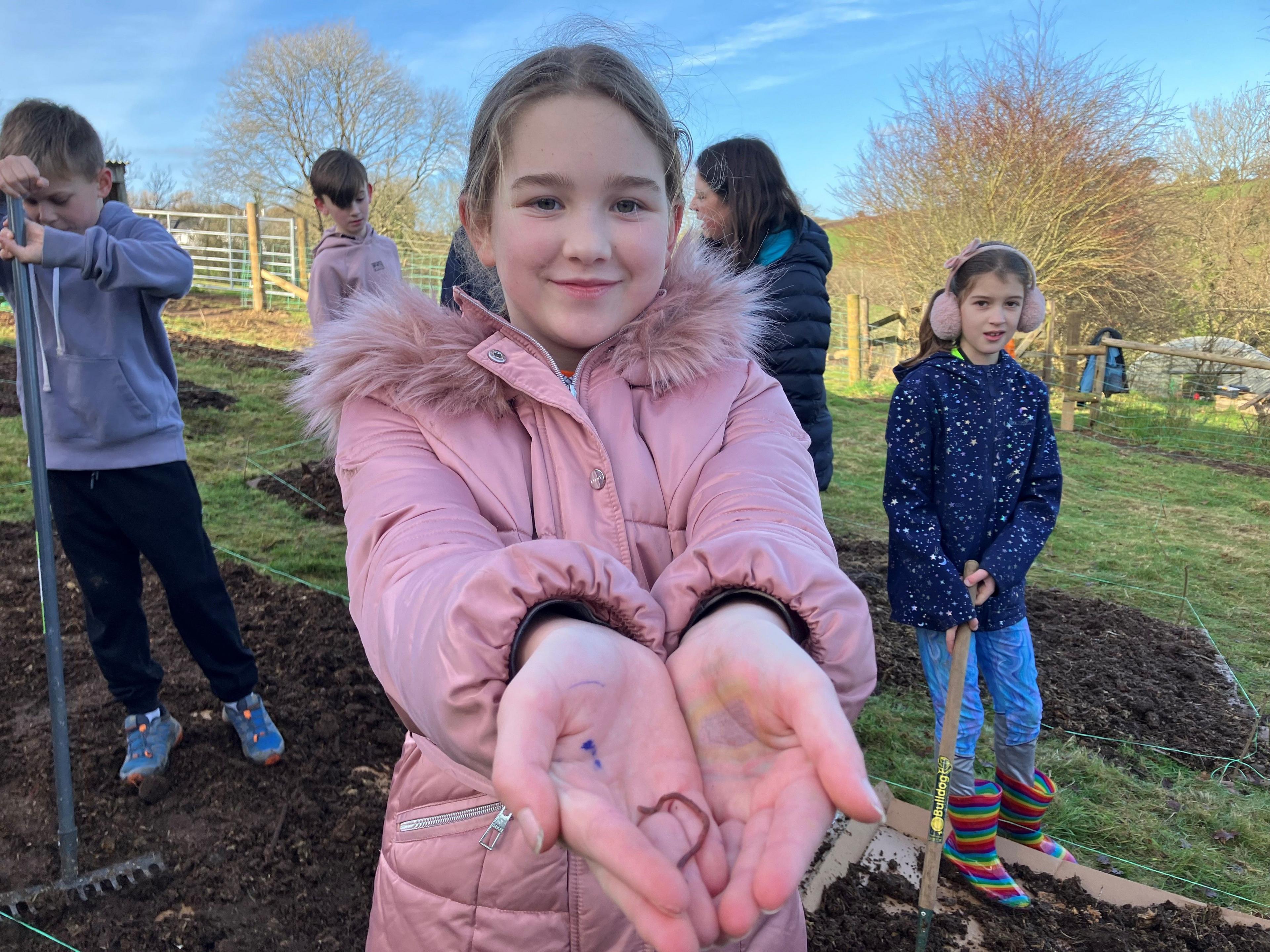 Pupil holding out worm