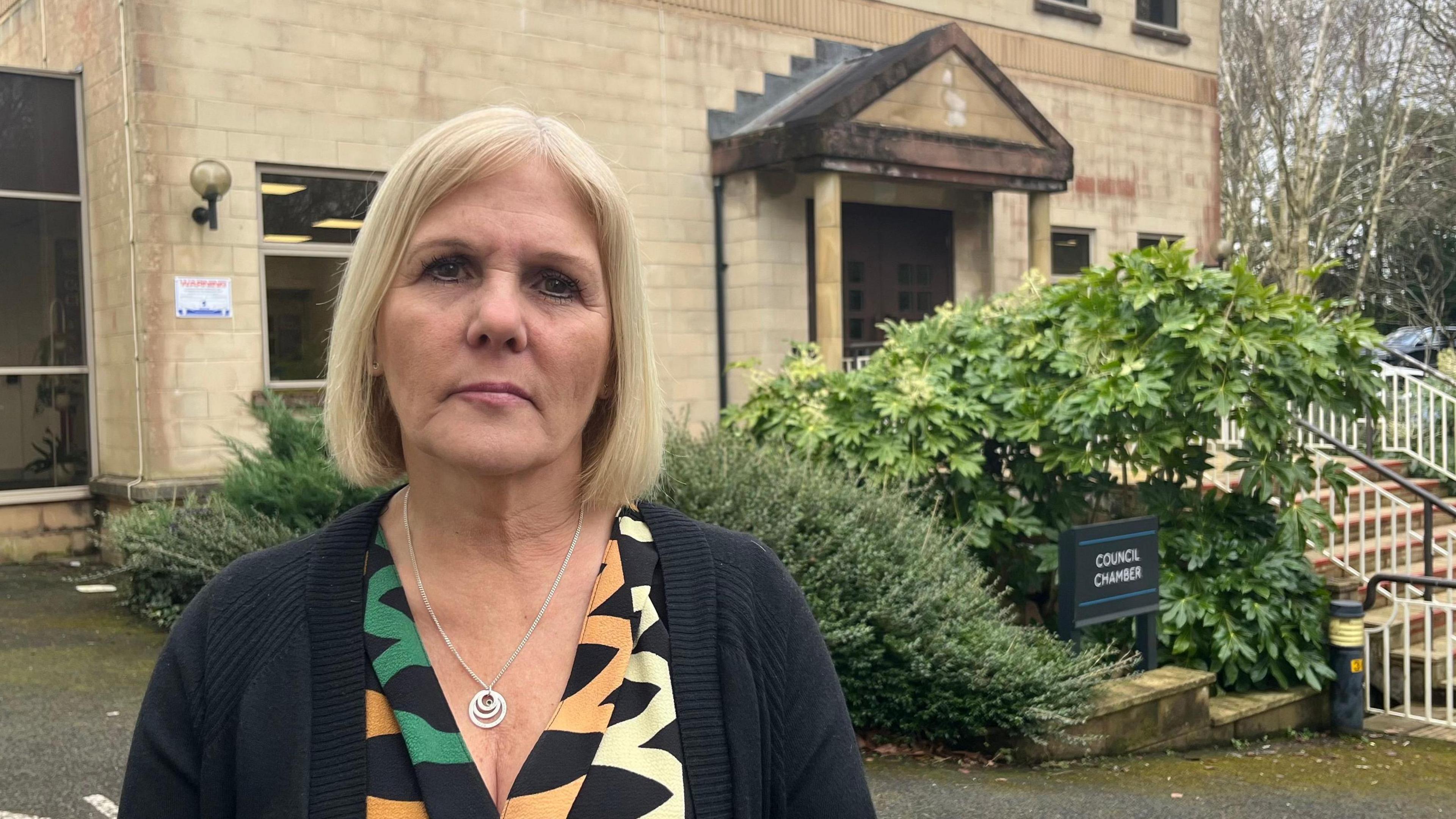 Nicky Hopwood, councillor for Woolwell on South Hams District Council, in a patterned dress and black cardigan