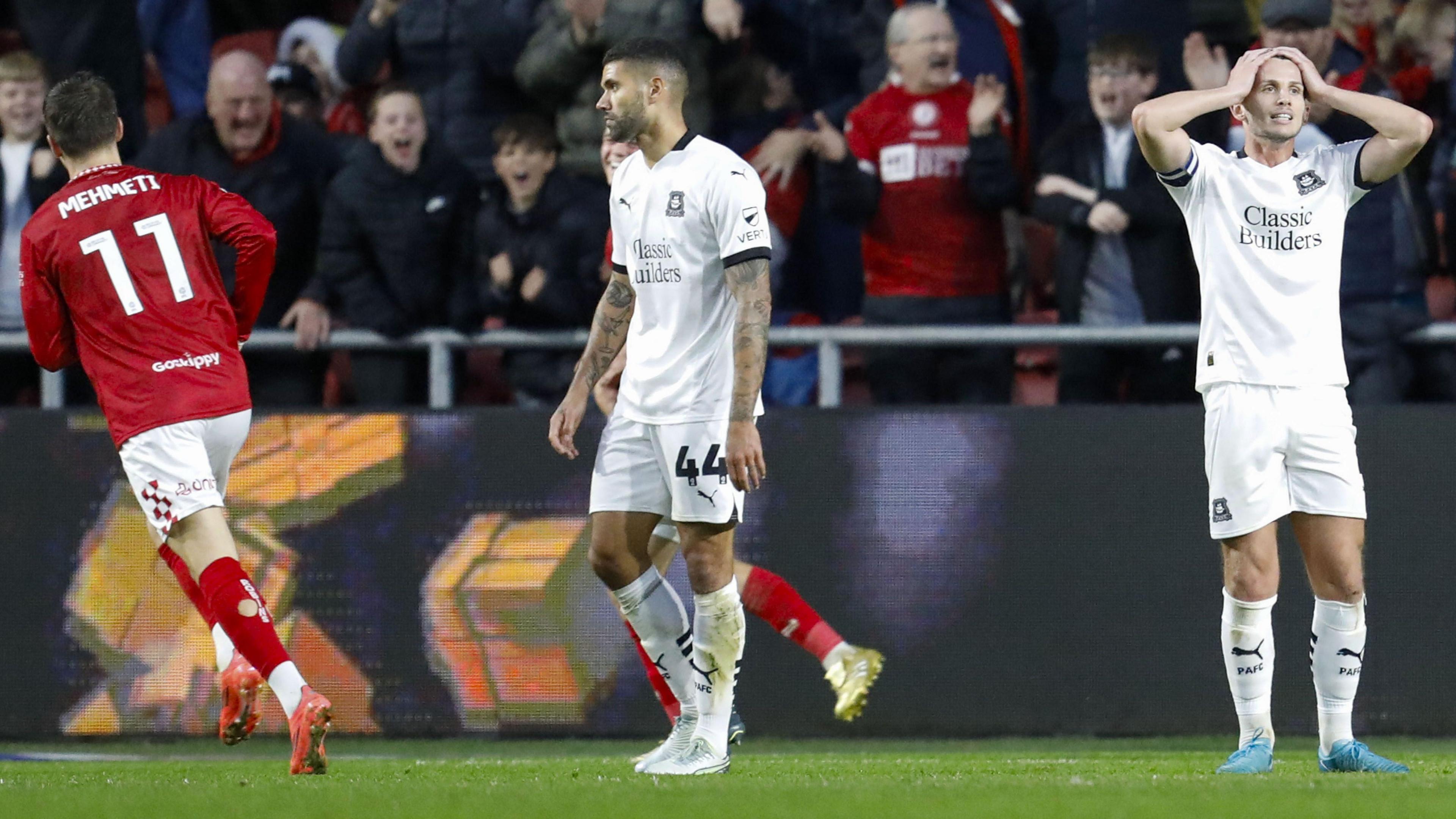 Plymouth players react as Anis Mehmeti peels away to celebrate in front of the Bristol City fans