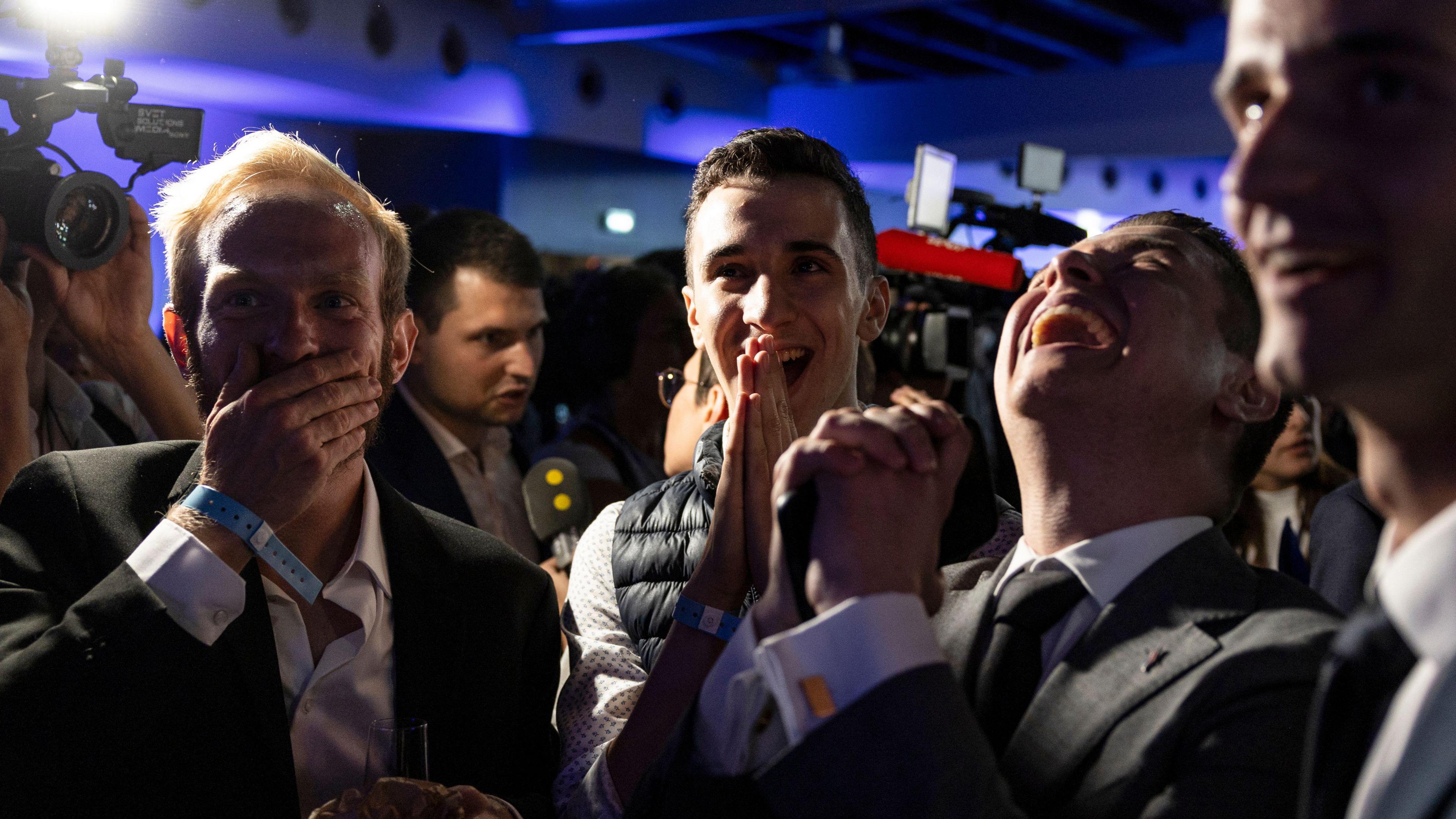 Supporters of France's National Rally react after President Macron's decision to call parliamentary elections