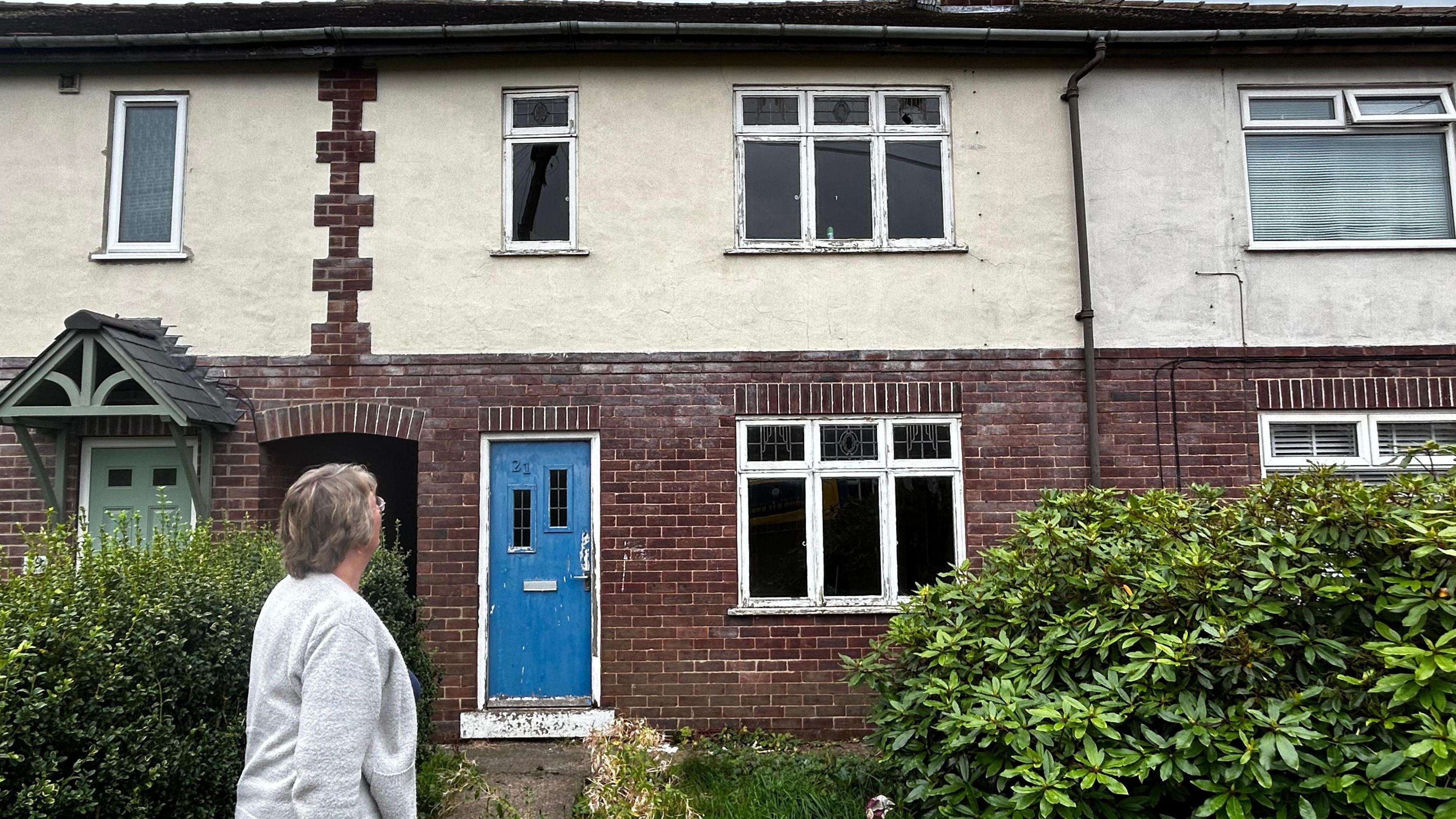 A terraced brick house in Knaresborough with a blue front door