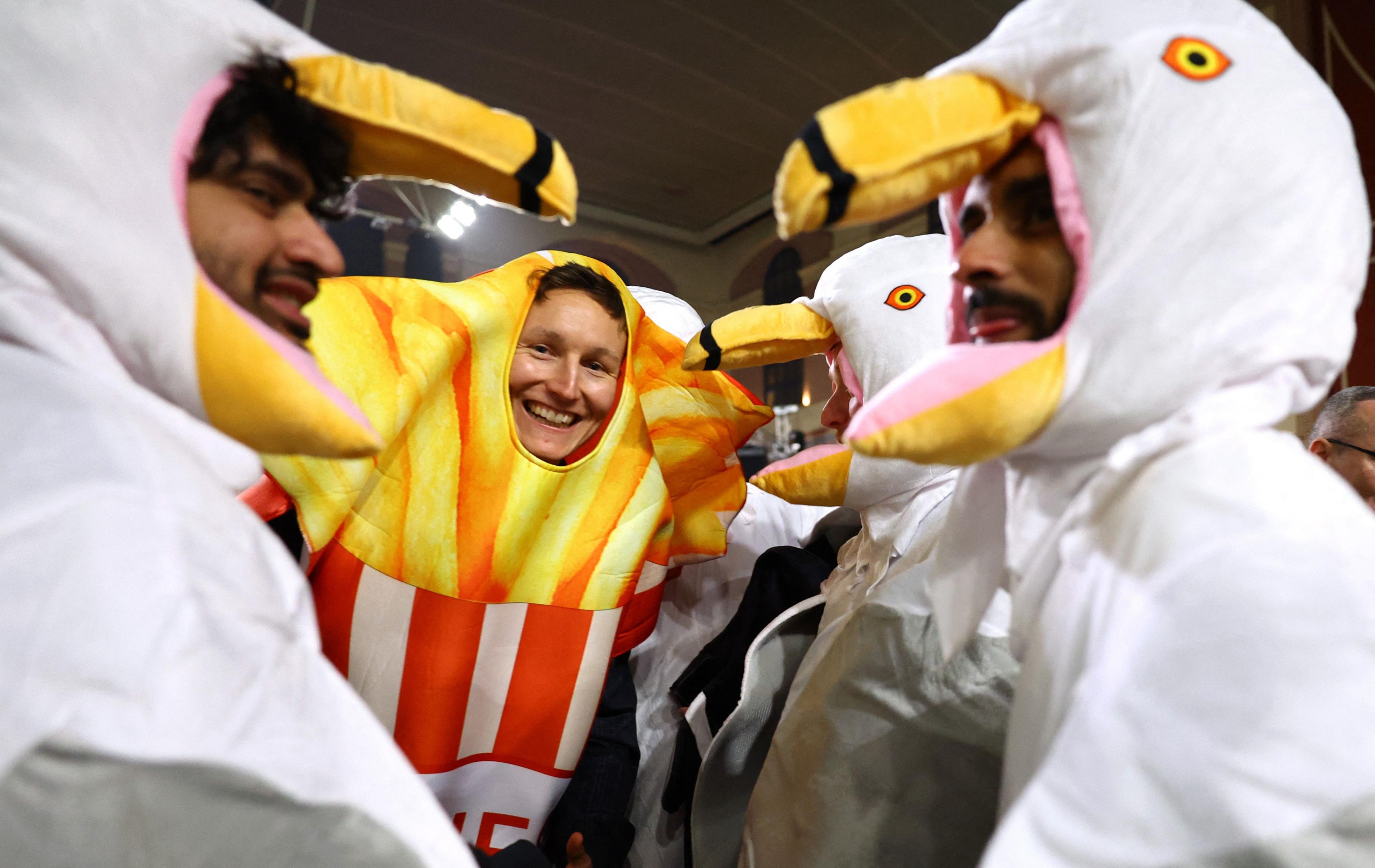 Three people dressed as seagulls and a person dressed as chips