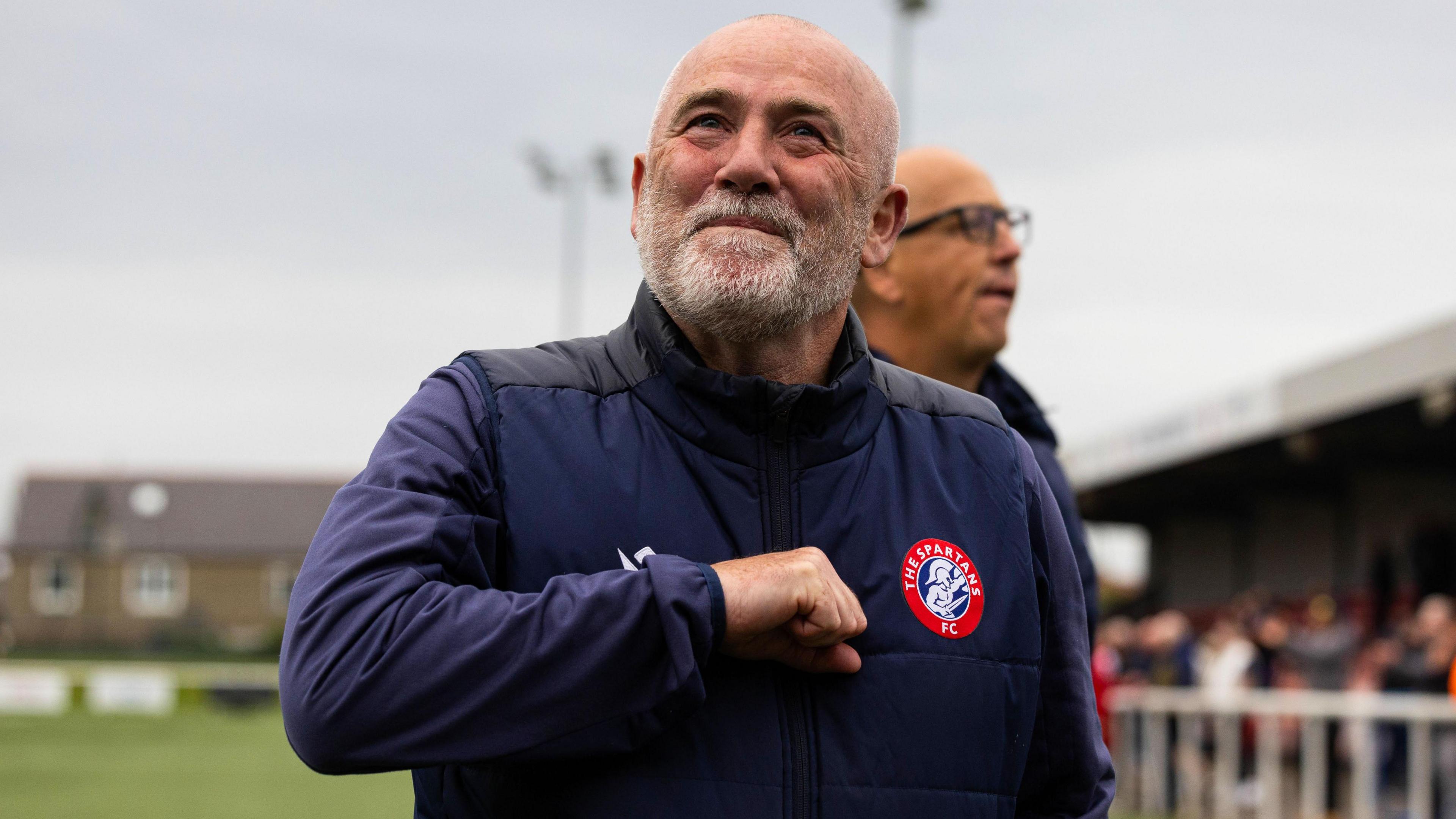 The Spartans manager Dougie Samuel pumps his chest after knocking Ross County out of the Premier Sports Cup