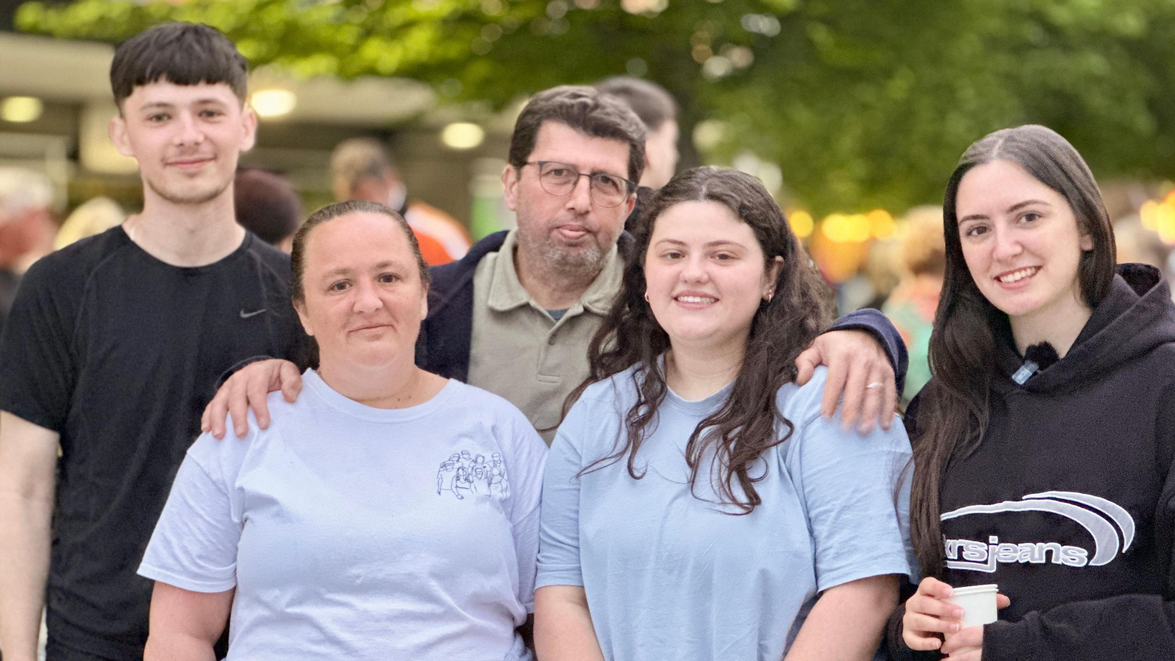 Five relatives of Mario Fassoli - three women and two men - look into the camera after completing the walk.