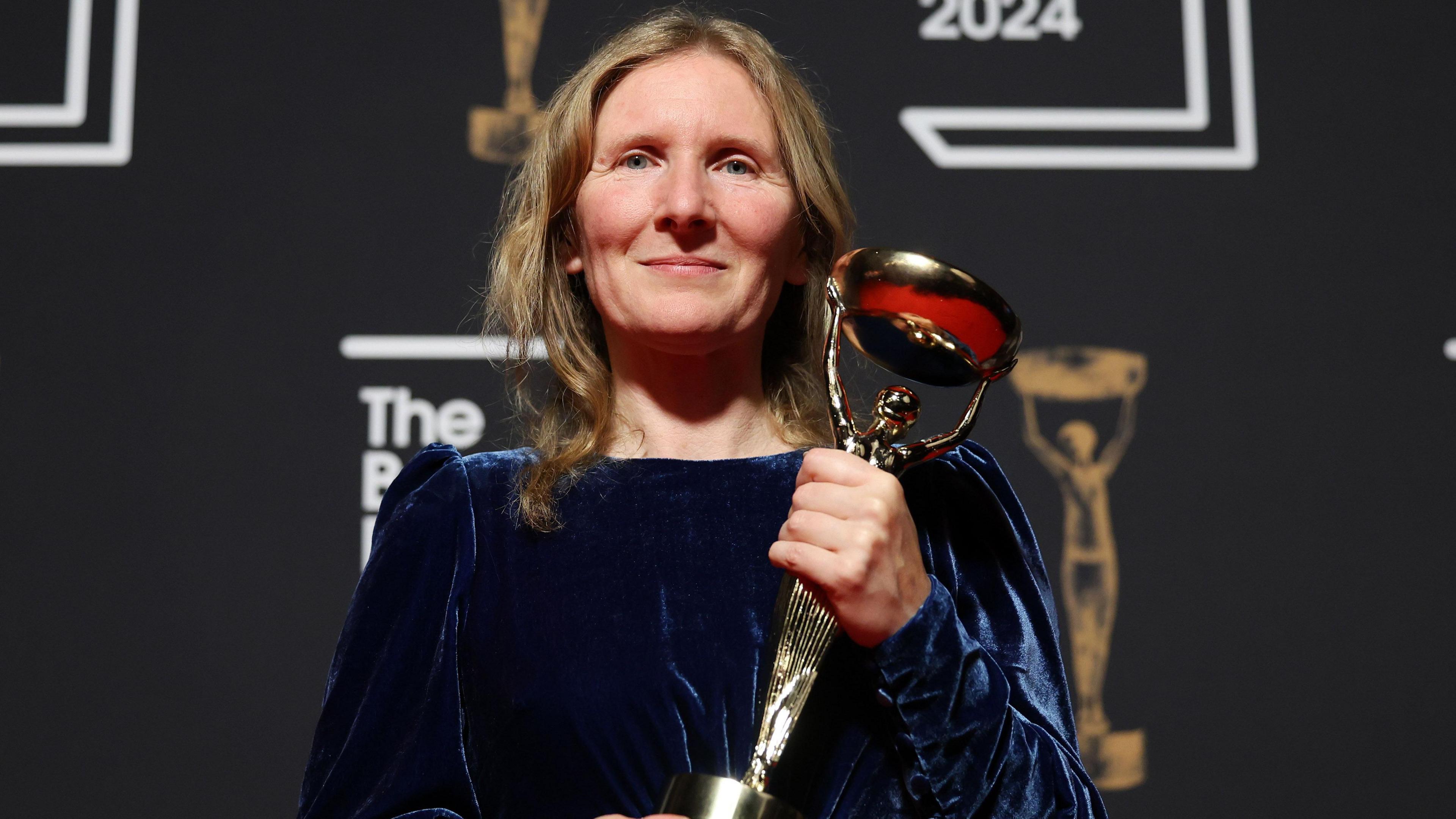 Samantha Harvey holding the Booker Prize trophy at the 2024 ceremony