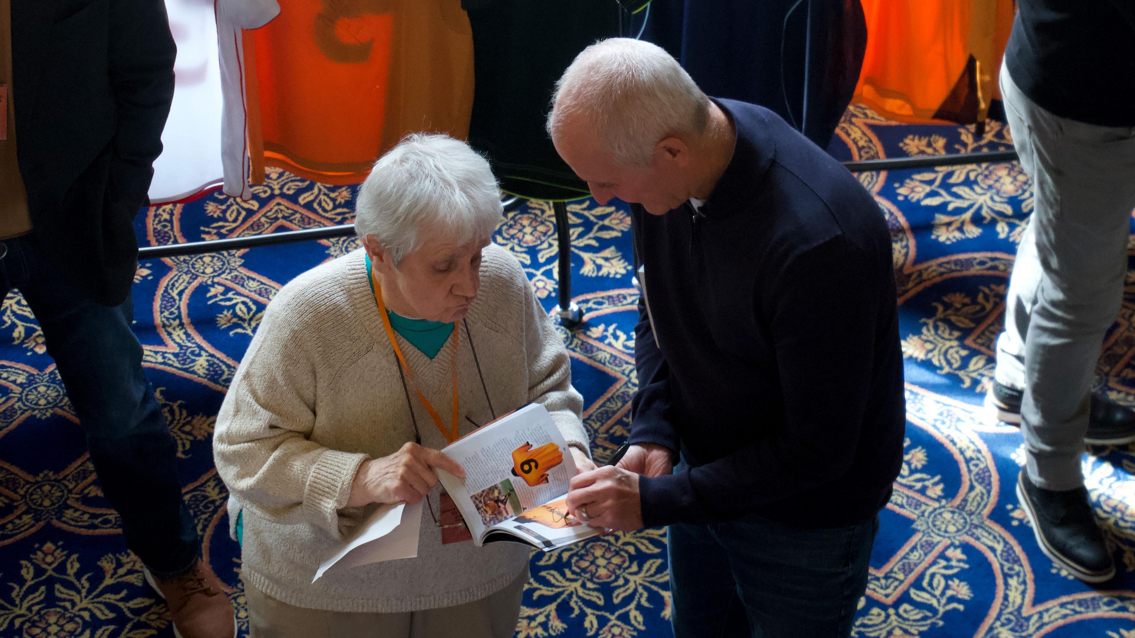 A woman gets a book signed by a former Wolves footballer