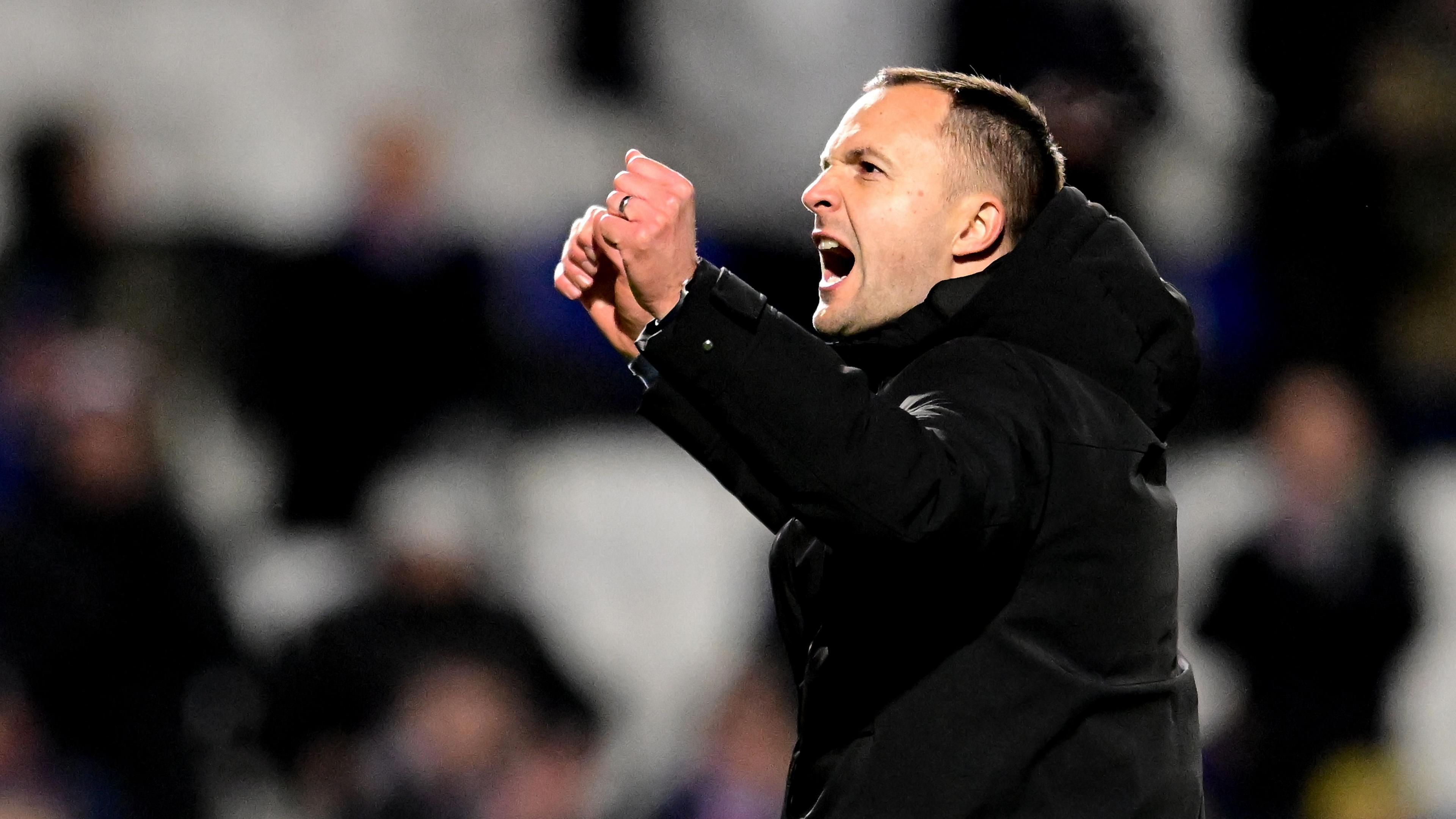 Birmingham City boss Chris Davies punches the air with both fists in celebration