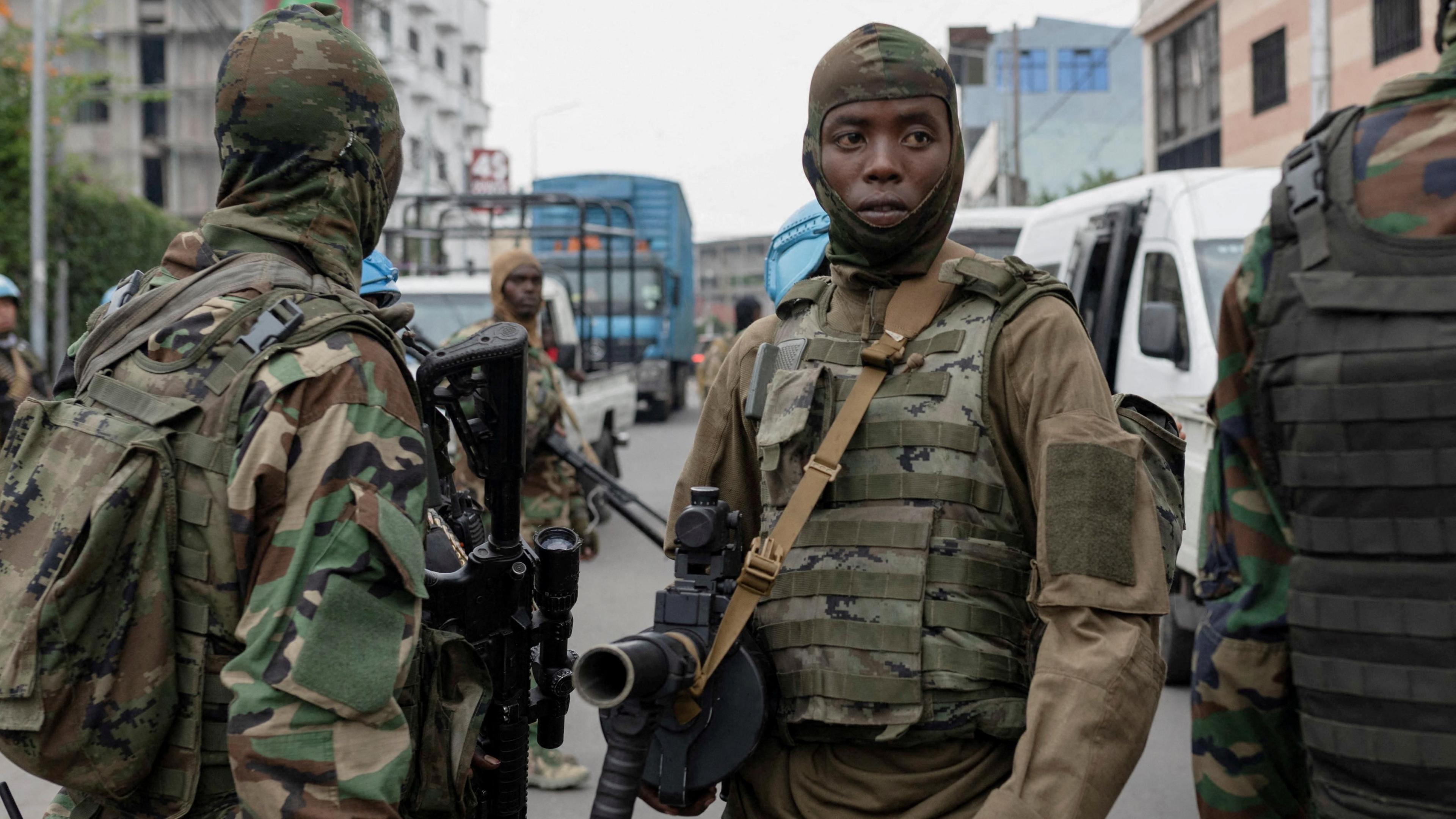 Members of the M23 rebel group supervise the exit of mercenary troops in the streets of Goma 