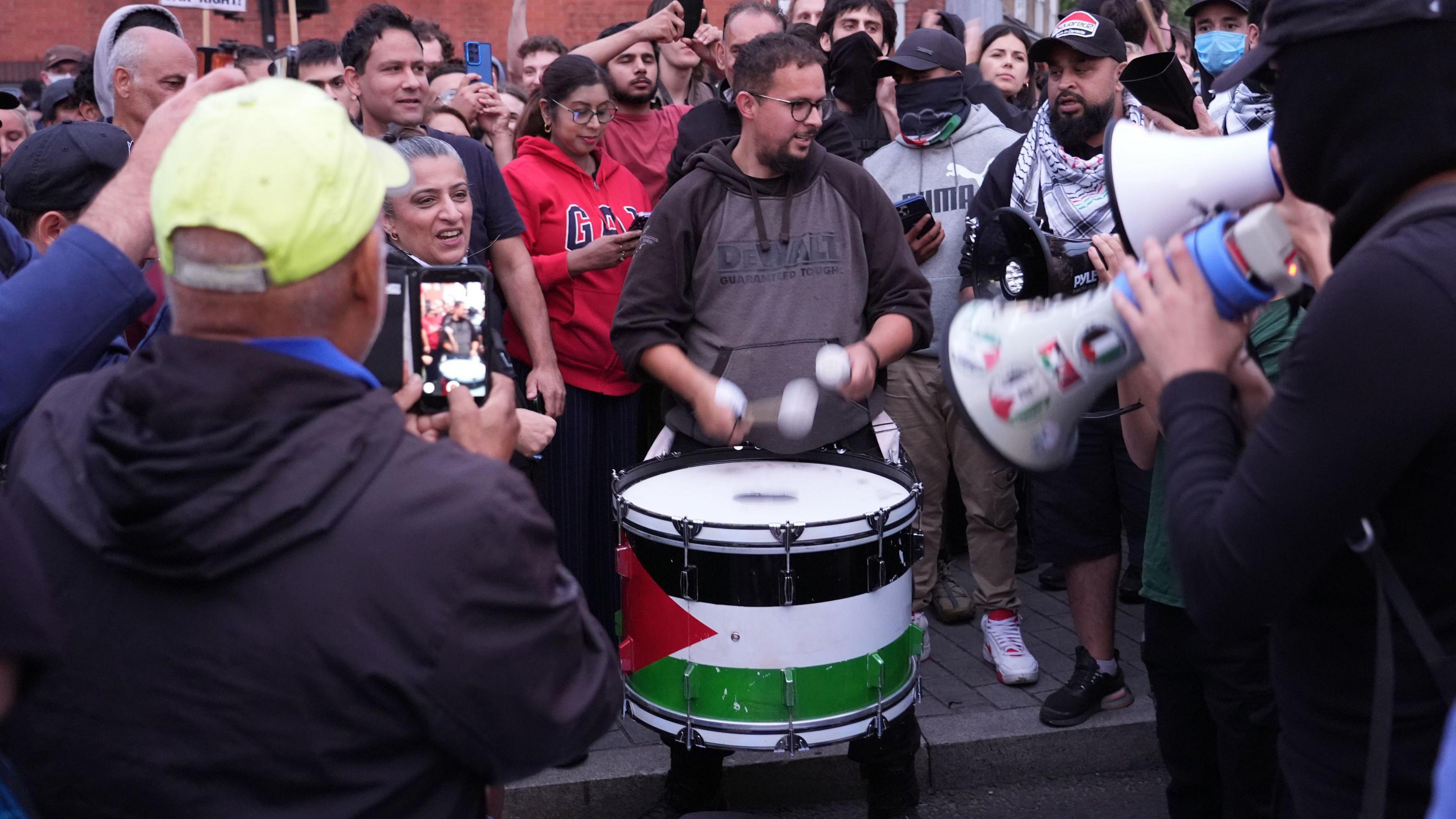 Demonstrators play drums at an anti-racism protest in Walthamstow