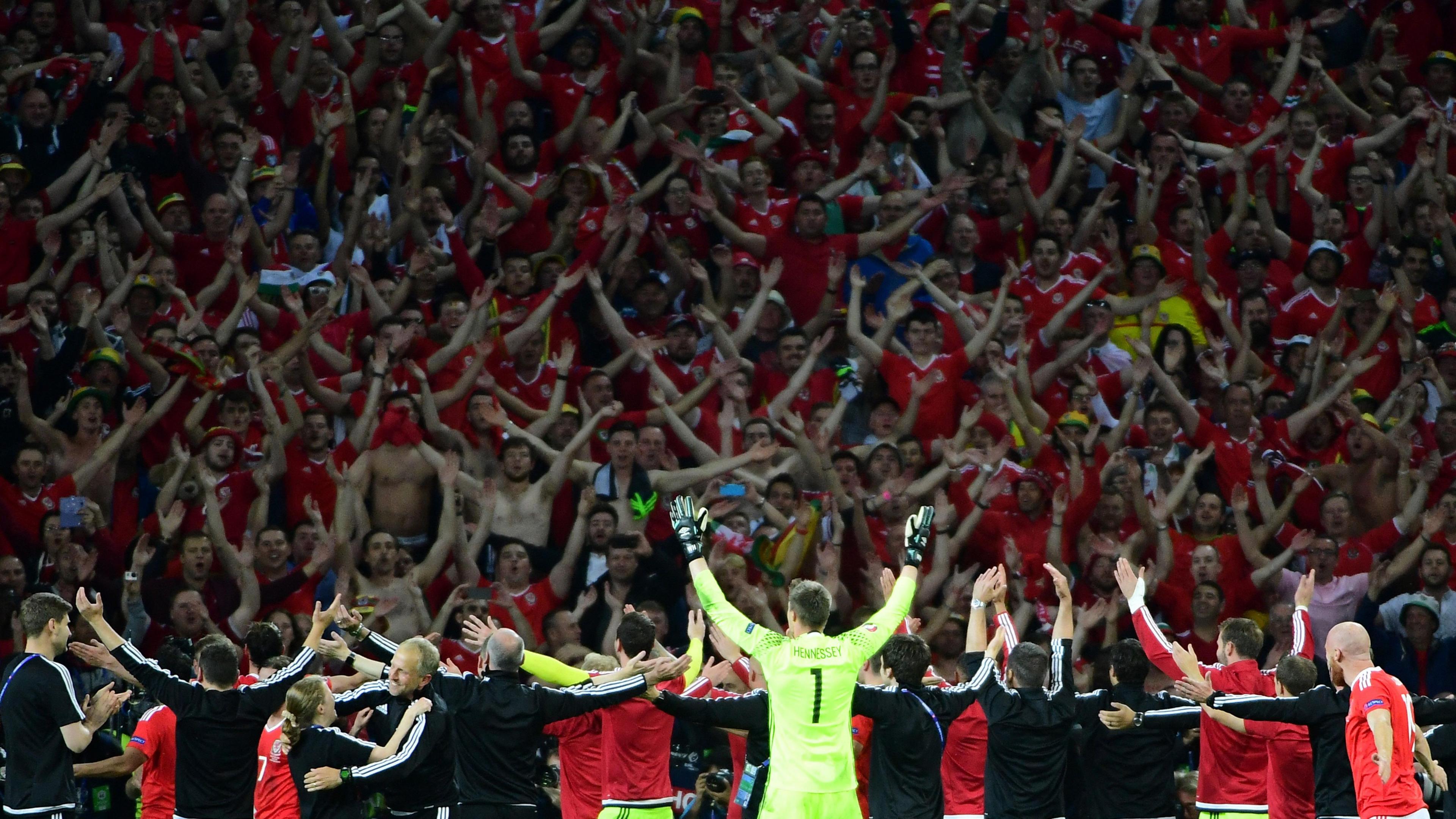 Wales players and staff celebrate with their fans after their Euro 2016 quarter-final win over Belgium