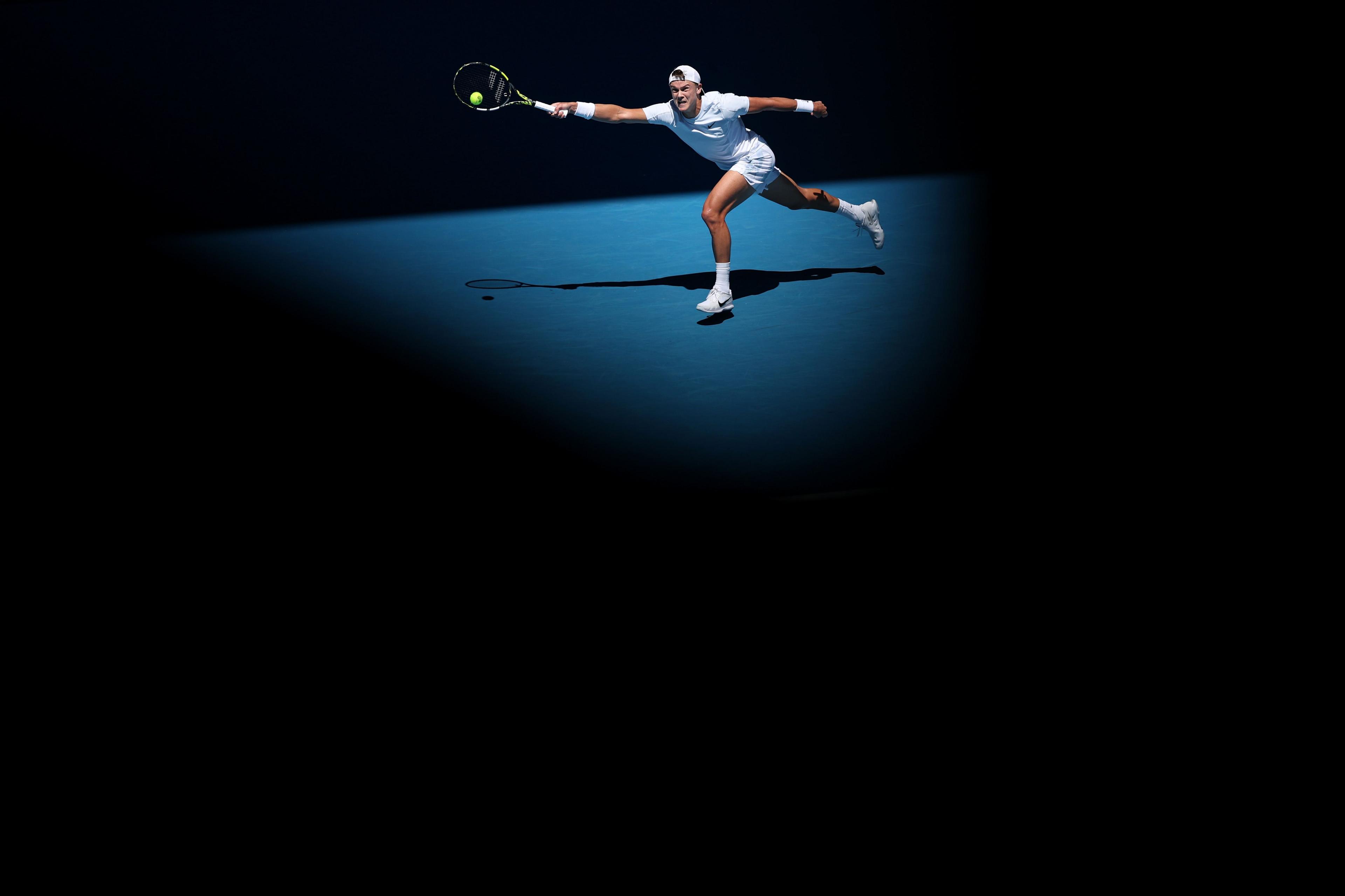 Denmark's Holger Rune plays a forehand against Zhizhen Zhang of China in the first round of the Australian Open in Melbourne, Australia