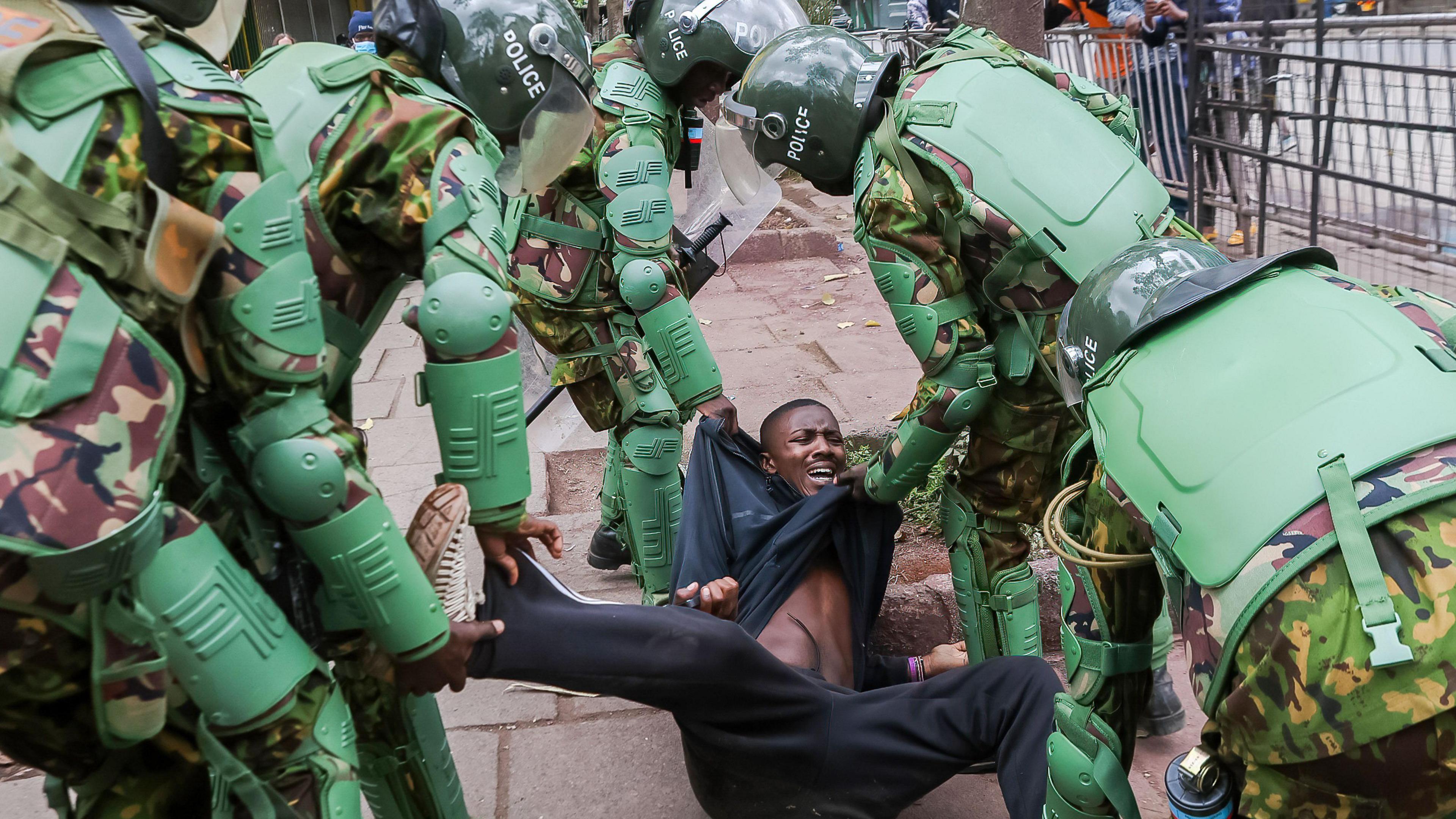 Anti-riot police arrest a demonstrator during a protest against high taxes. 