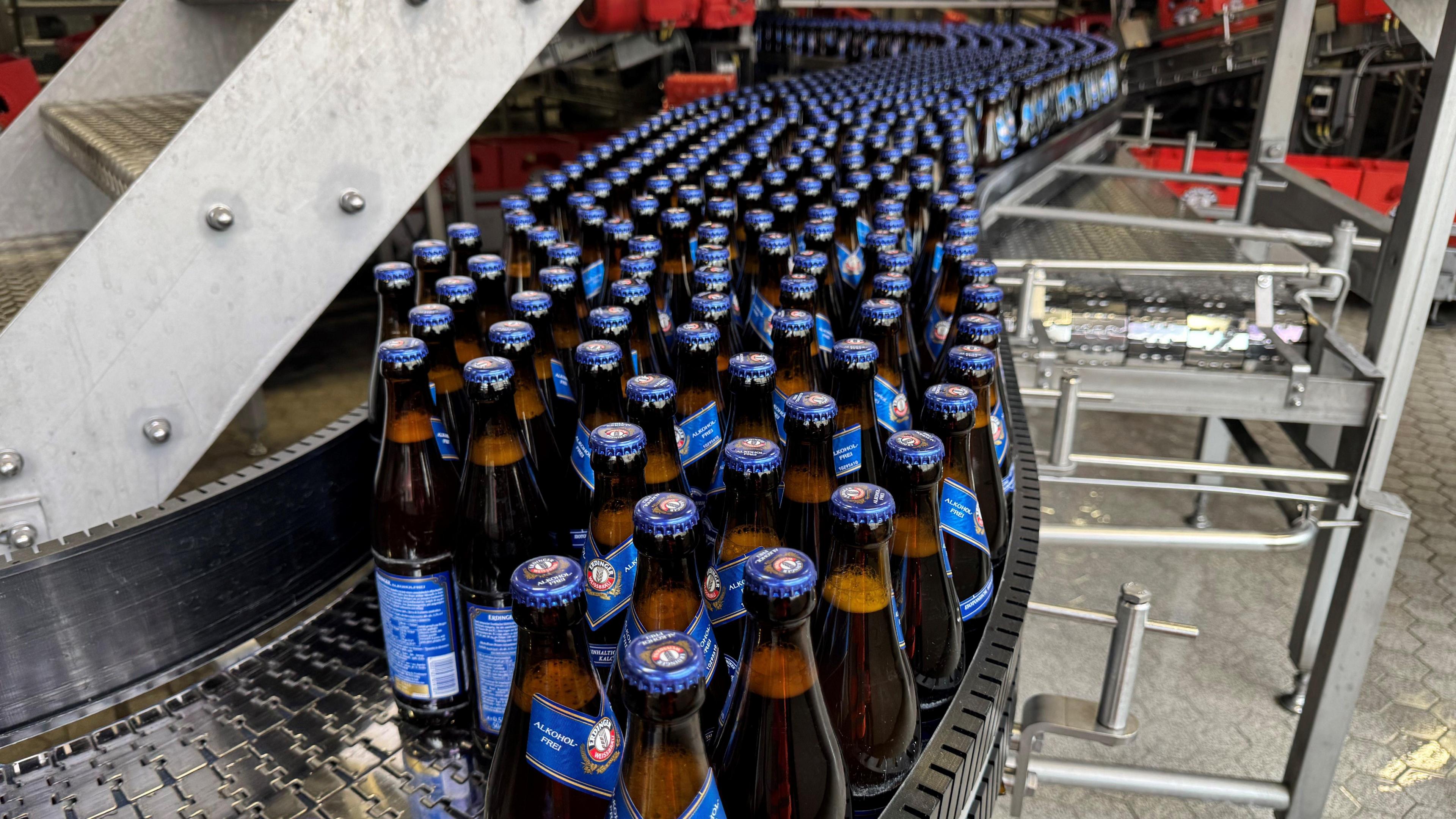 Bottles of the non-alcoholic beer, Erdinger, on a conveyor belt.