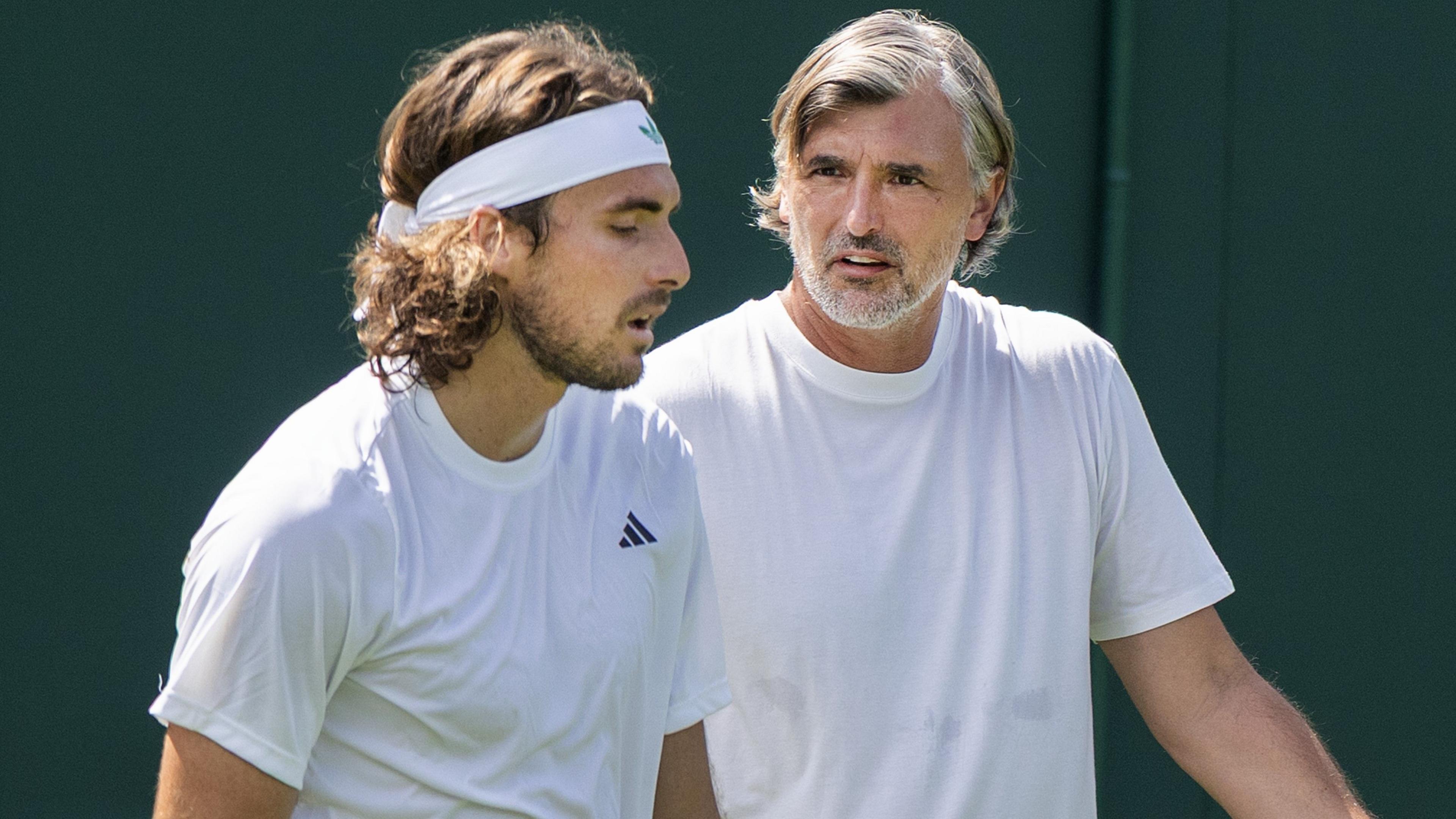 Stefanos Tsitsipas and Goran Ivanisevic speak during a practise session at Wimbledon