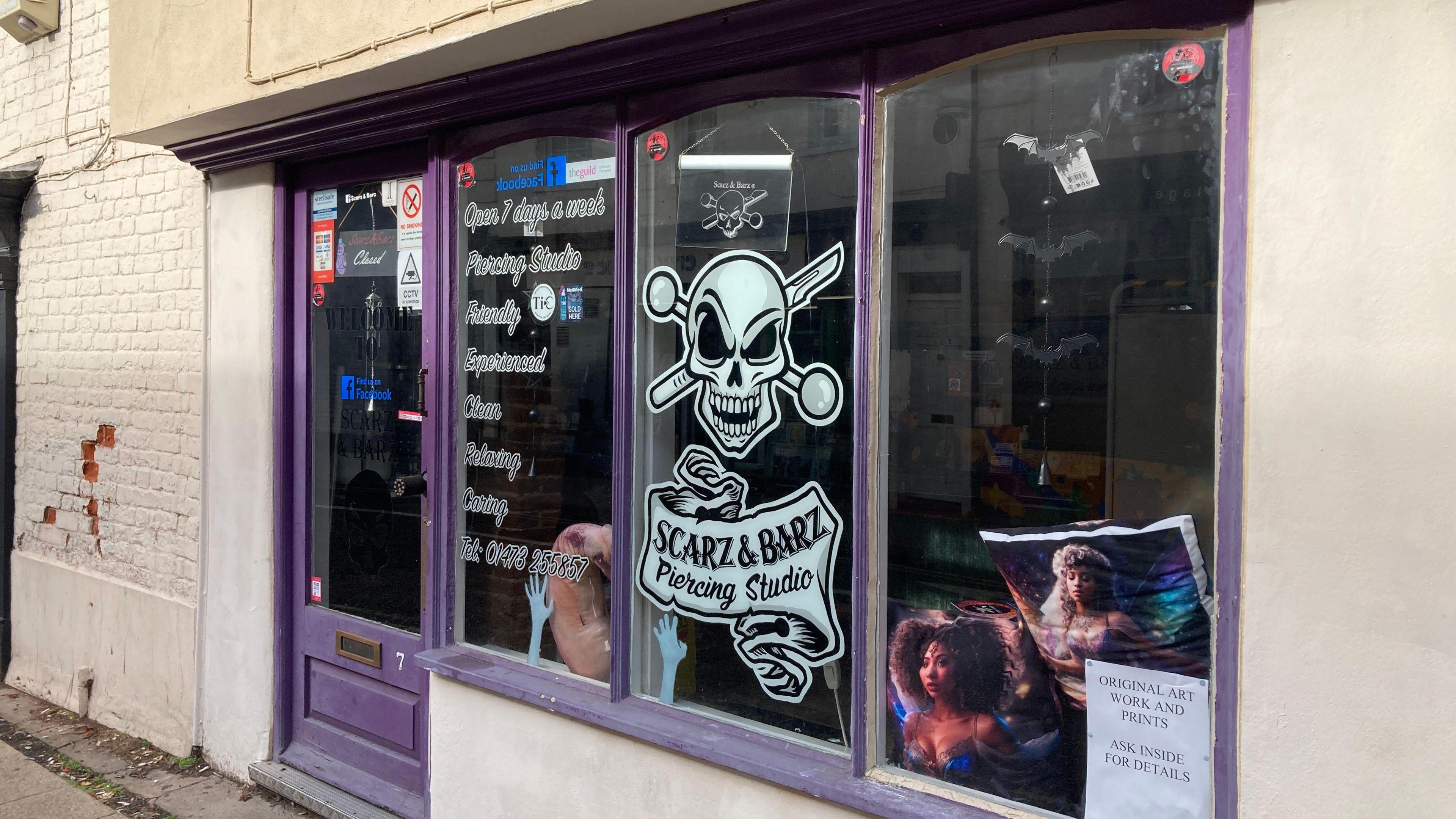 The purple frontage of Scarz&Barz piercing studio.