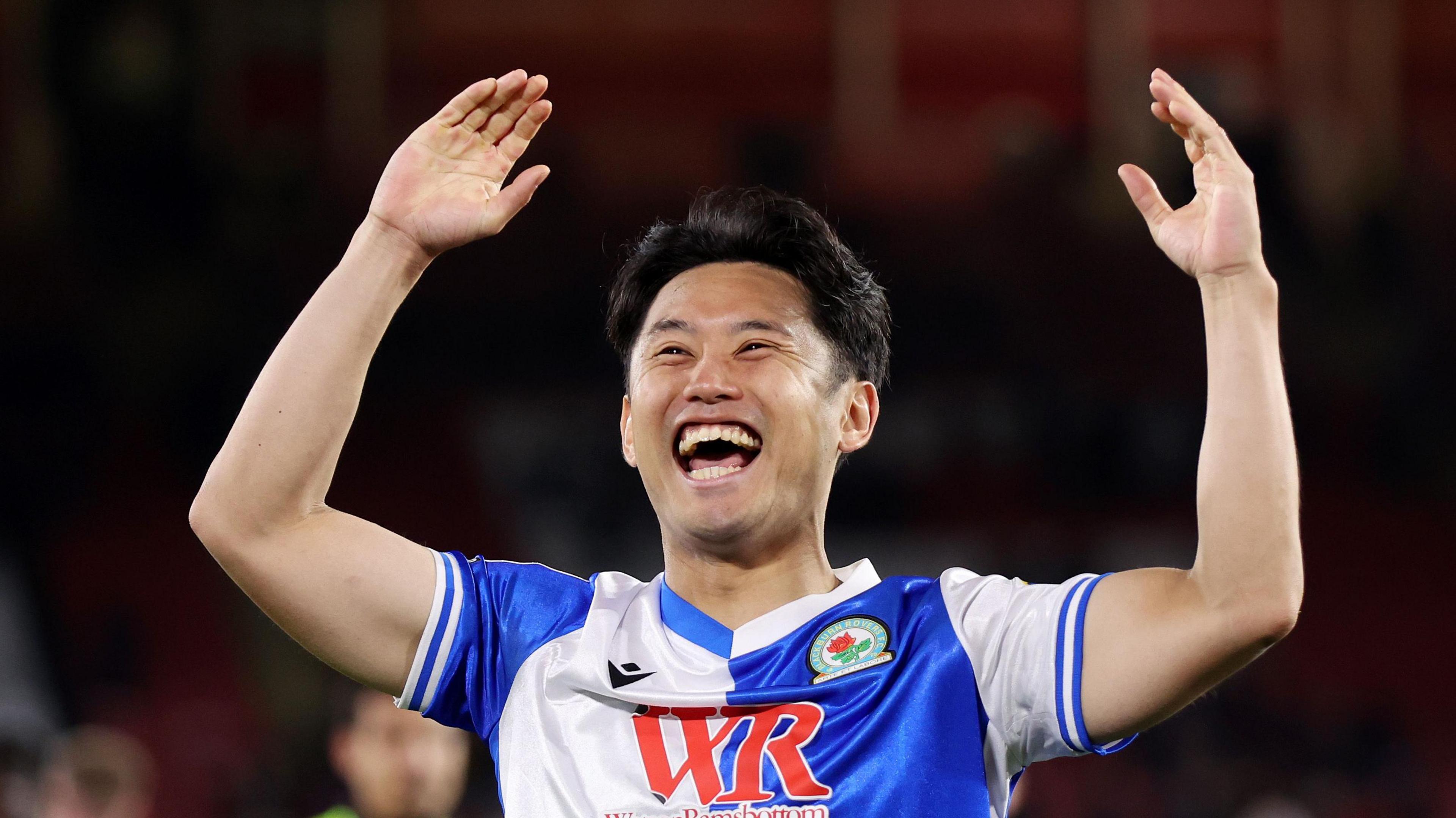 Blackburn Rovers' Ryoya Morishita raises his arms and smiles after scoring against Sheffield United