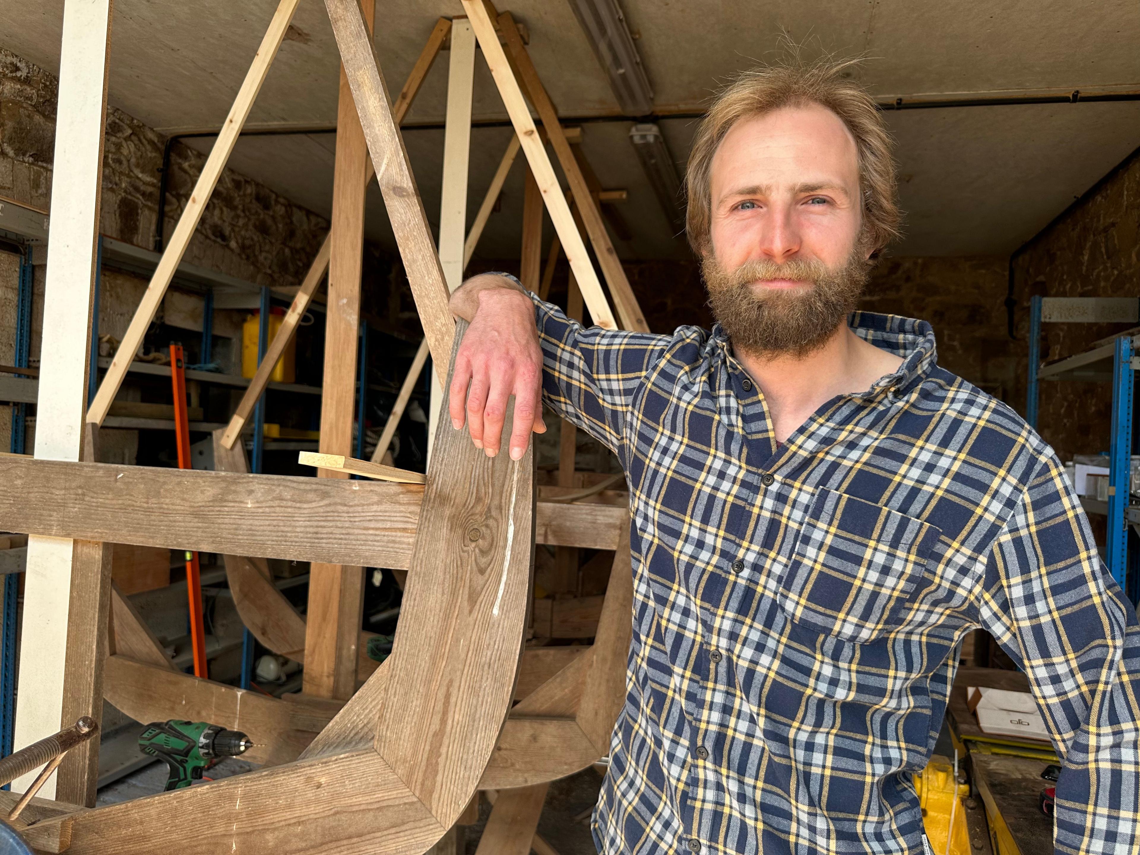 Boat builder with scaffolding for the vessel