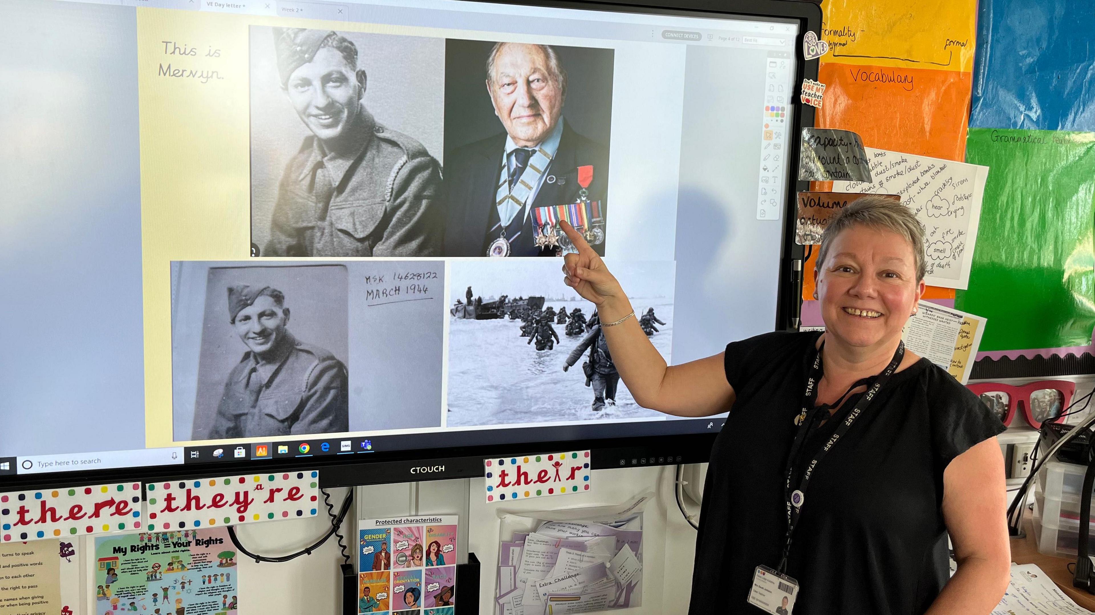 Miss Jackson stands in front of a screen showing pictures of Mervyn when he enlisted and when he turned 100.
