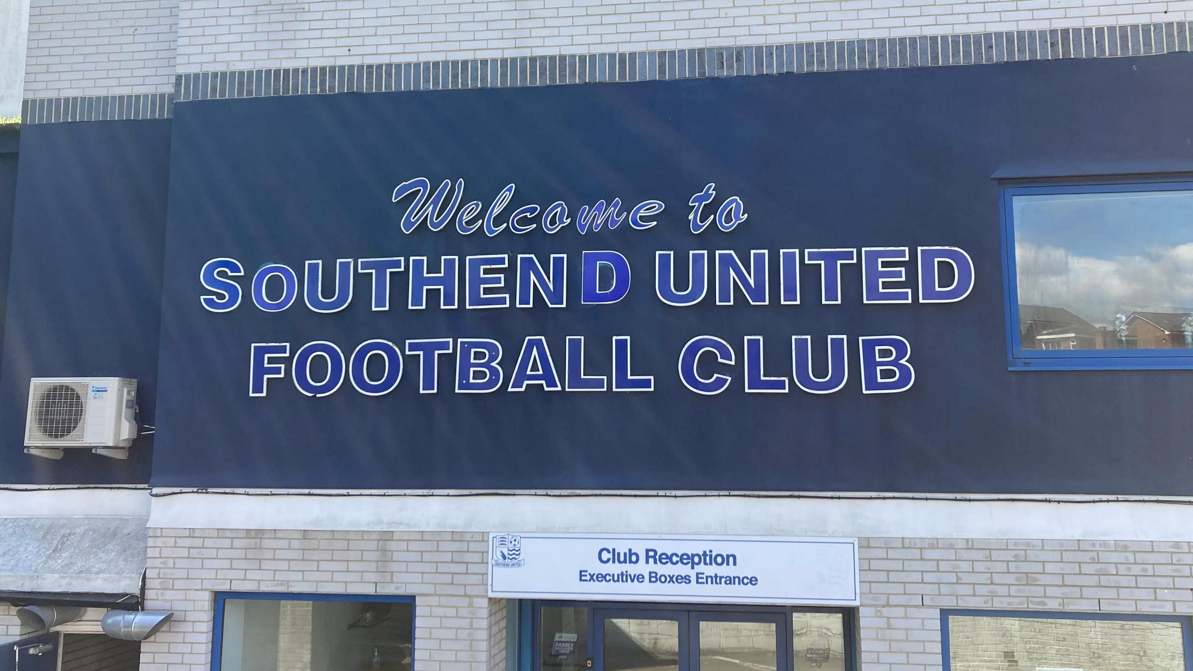 The entrance to the club reception at Roots Hall, which has the lettering "welcome to Southend United Football Club" on the wall above the doors.