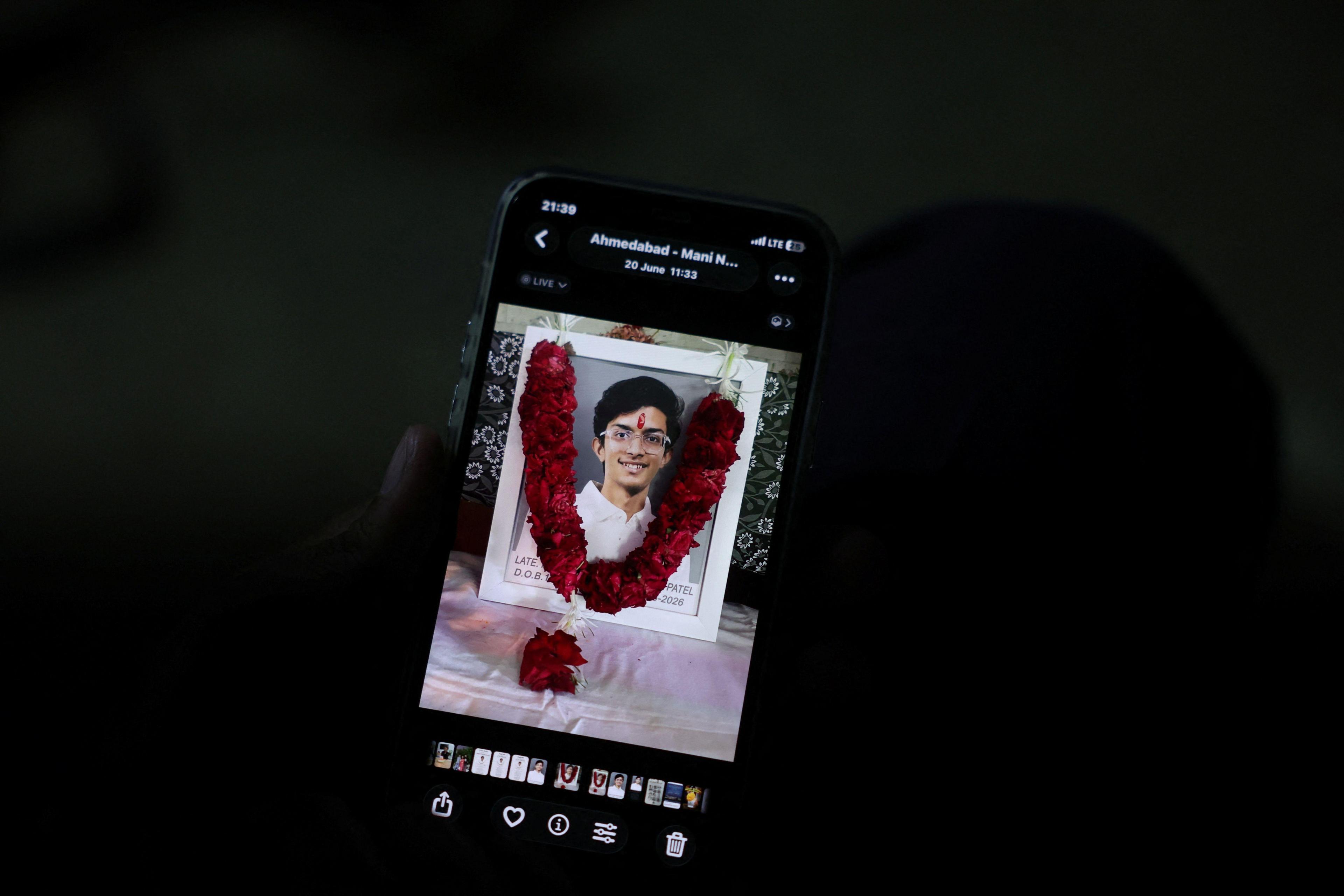 Prashant Patel, 45, shows a photo of his 17-year-old son Kahaan Patel, who took his own life ahead of the NEET exam retest, in Ahmedabad