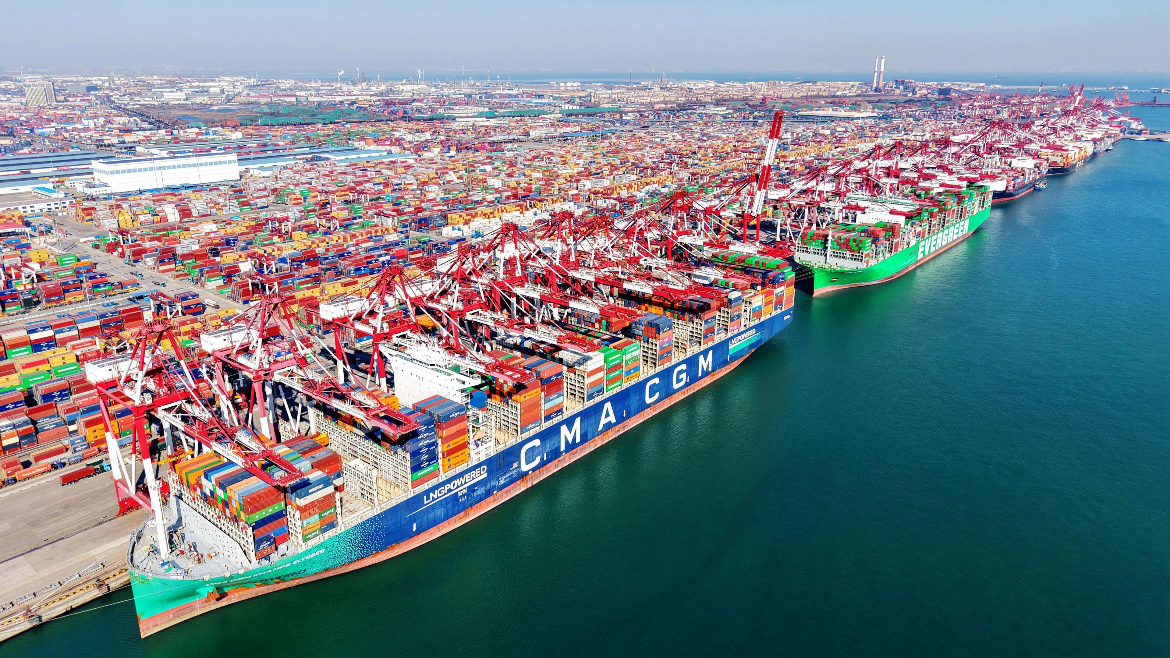 Cargo ships load and unload foreign trade containers at the fully automated terminal of Qingdao Port in China.