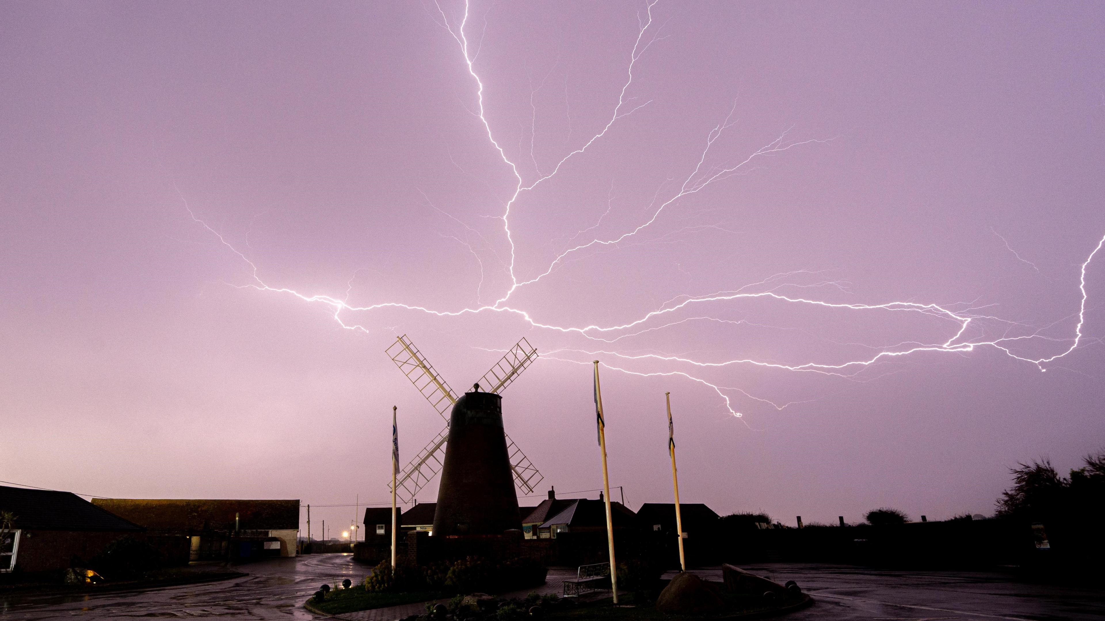 Lightning strikes near a windmill in West Sussex