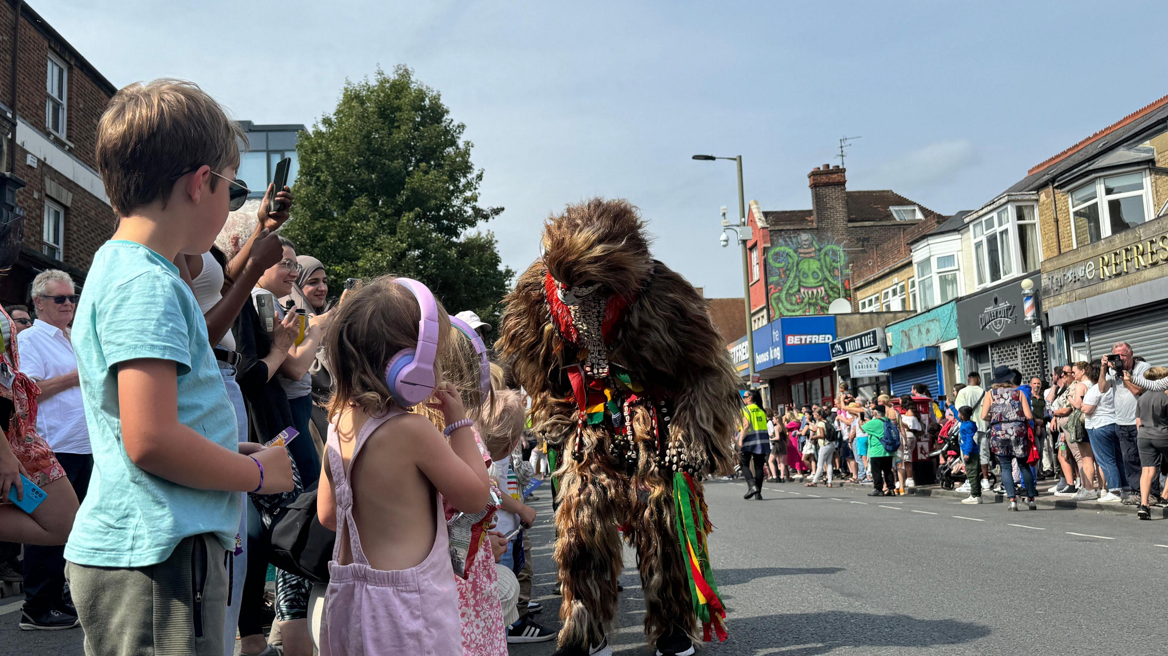 Kids stood on the paths whilst the parade takes place.