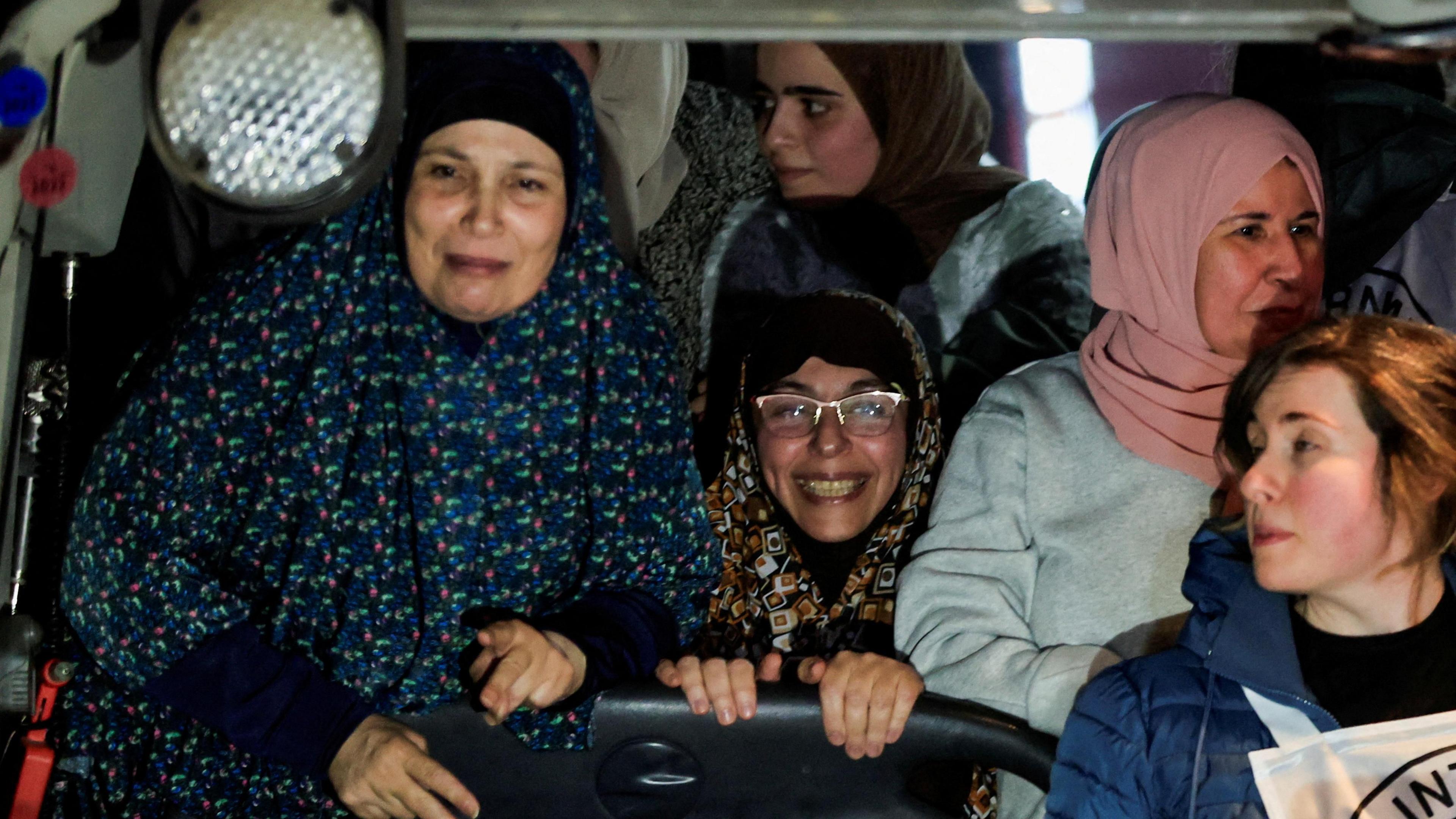 Palestinian women gesture after being freed from Israeli jails as part of a Gaza ceasefire and hostage release deal, in the occupied West Bank (20 January 2025)