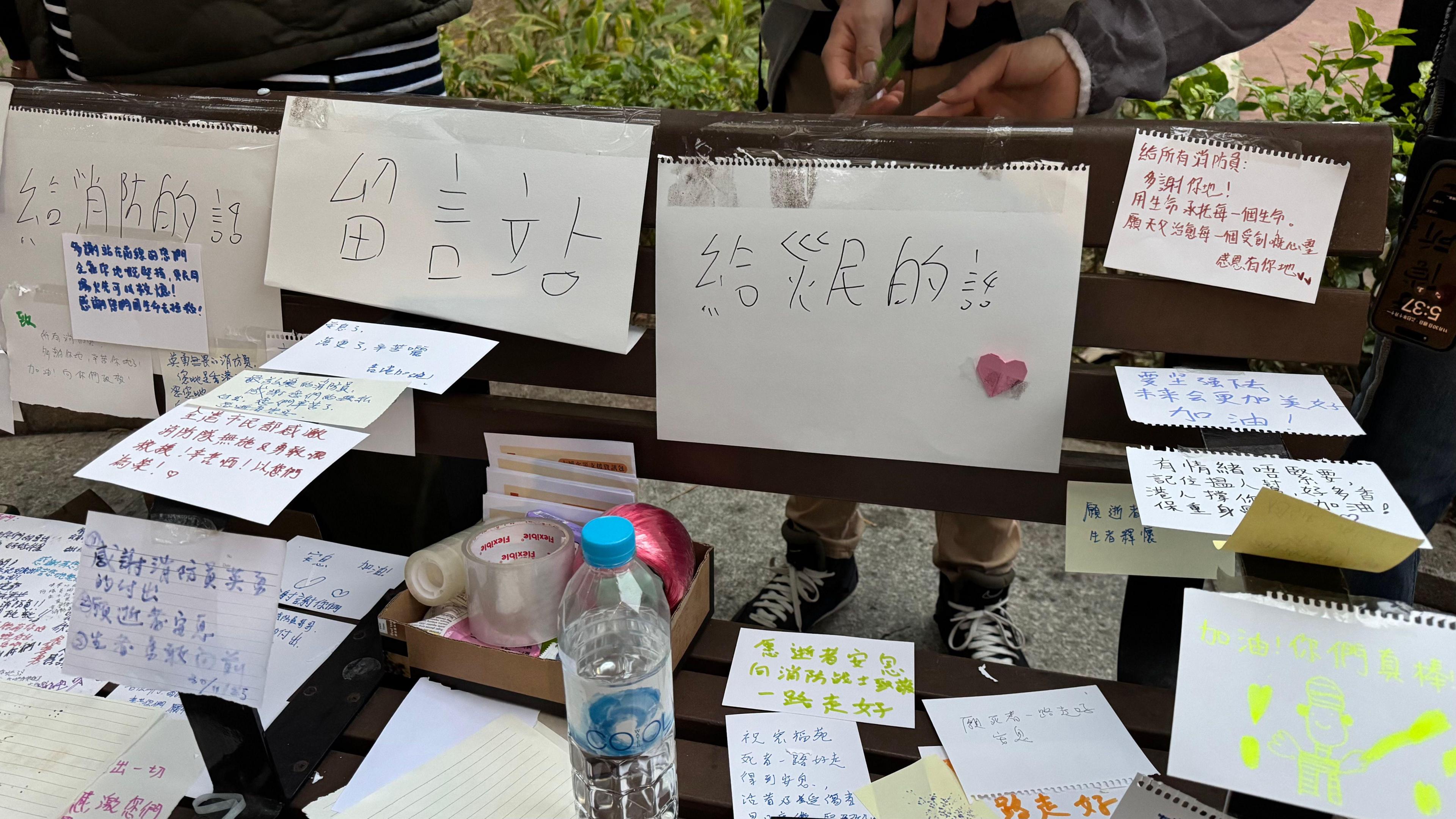 Hand-written tributes On pieces of white paper