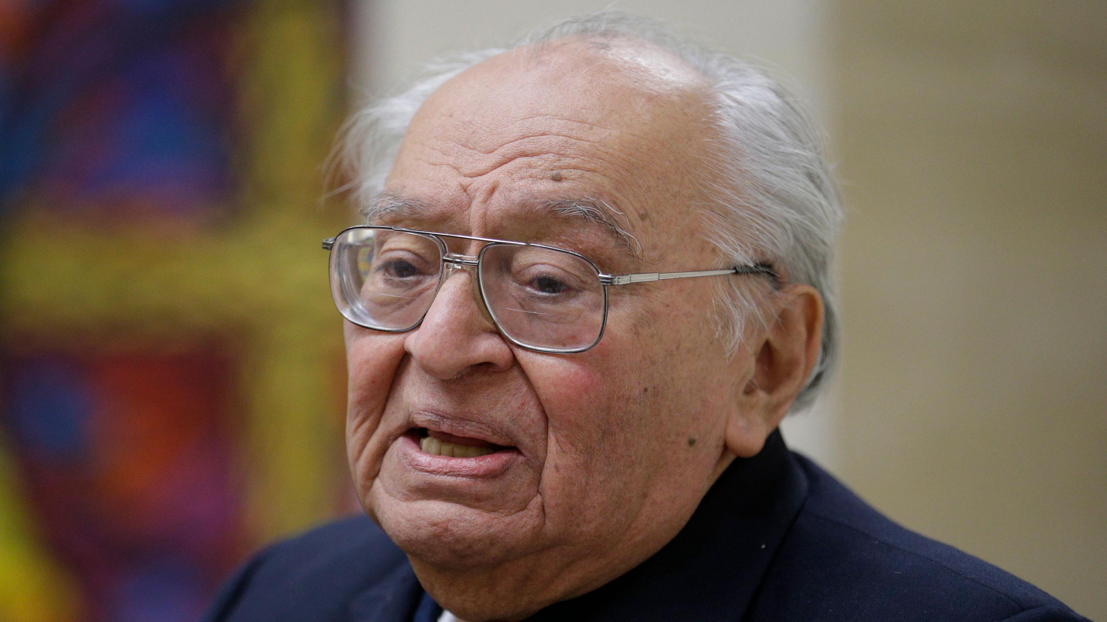 Peruvian theologian and Dominican priest Gustavo Gutierrez, wearing a cassock and glasses, speaks during a news conference in 2014. 