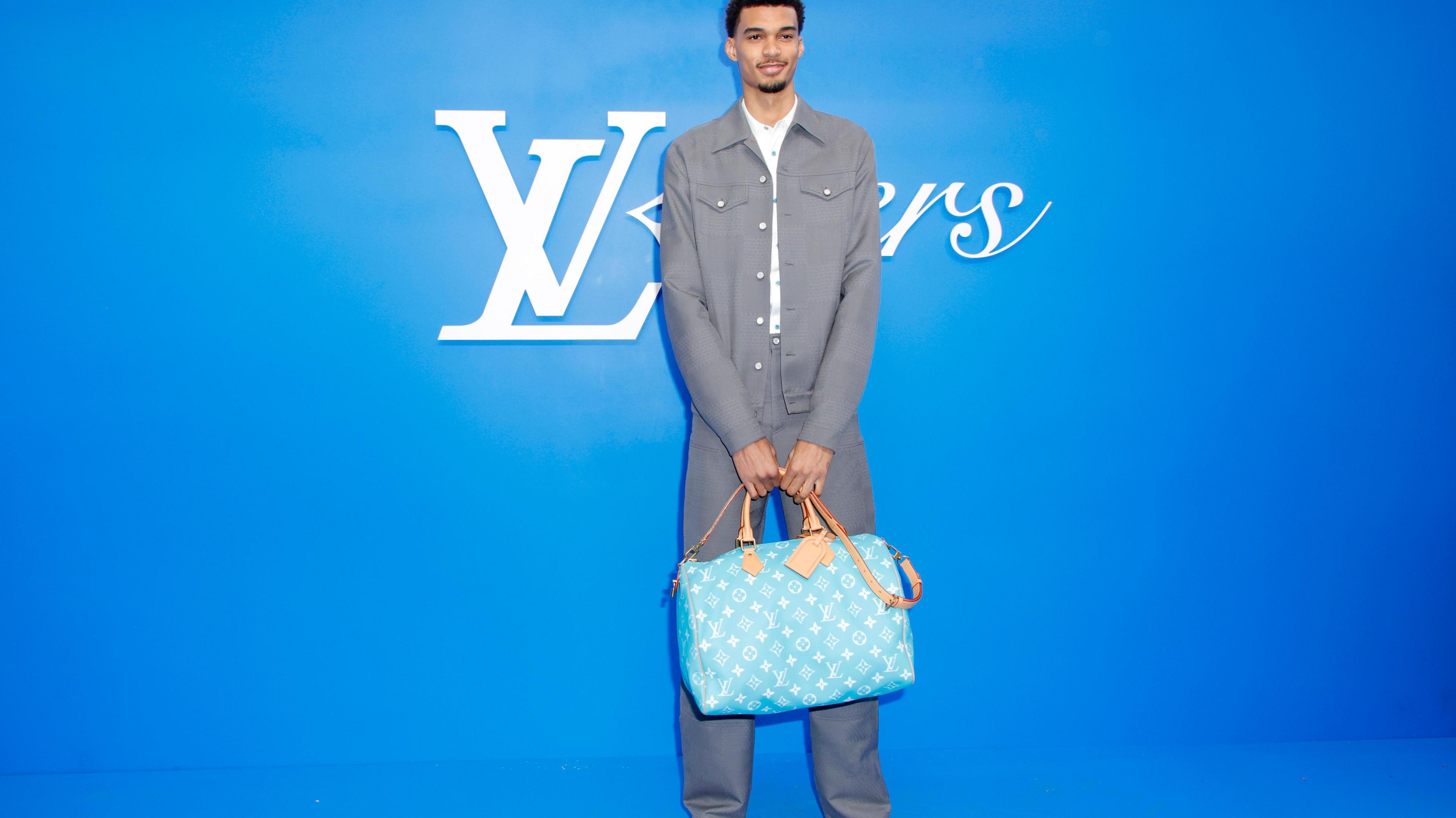 Victor Wembanyama posing on a red carpet for Louis Vuitton