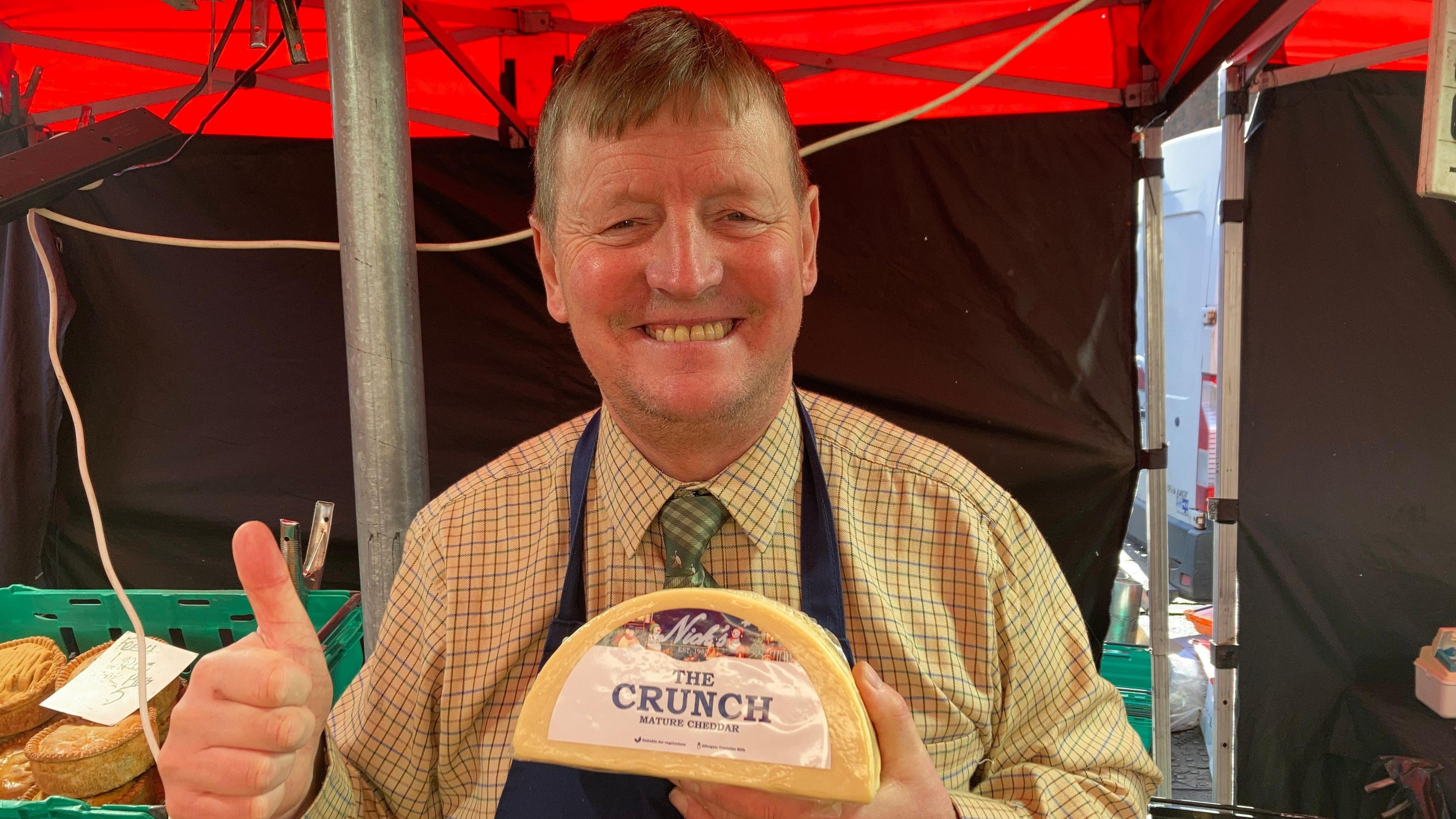 Trader Nick White holding a block of cheese
