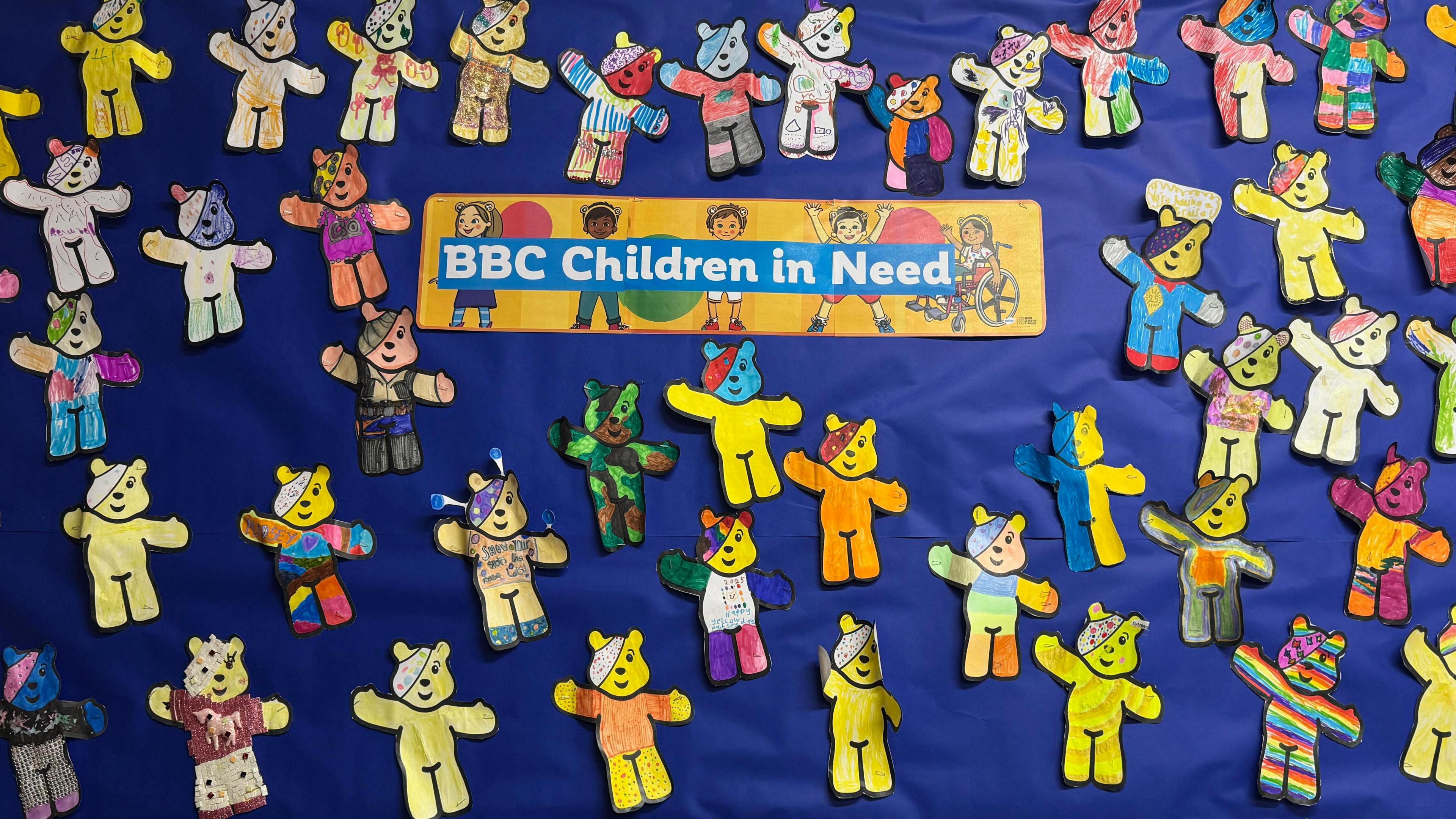 A display board full of Pudsey Bears. Each bear has been coloured and decorated. There is a sign on the board reading "BBC Children in Need"