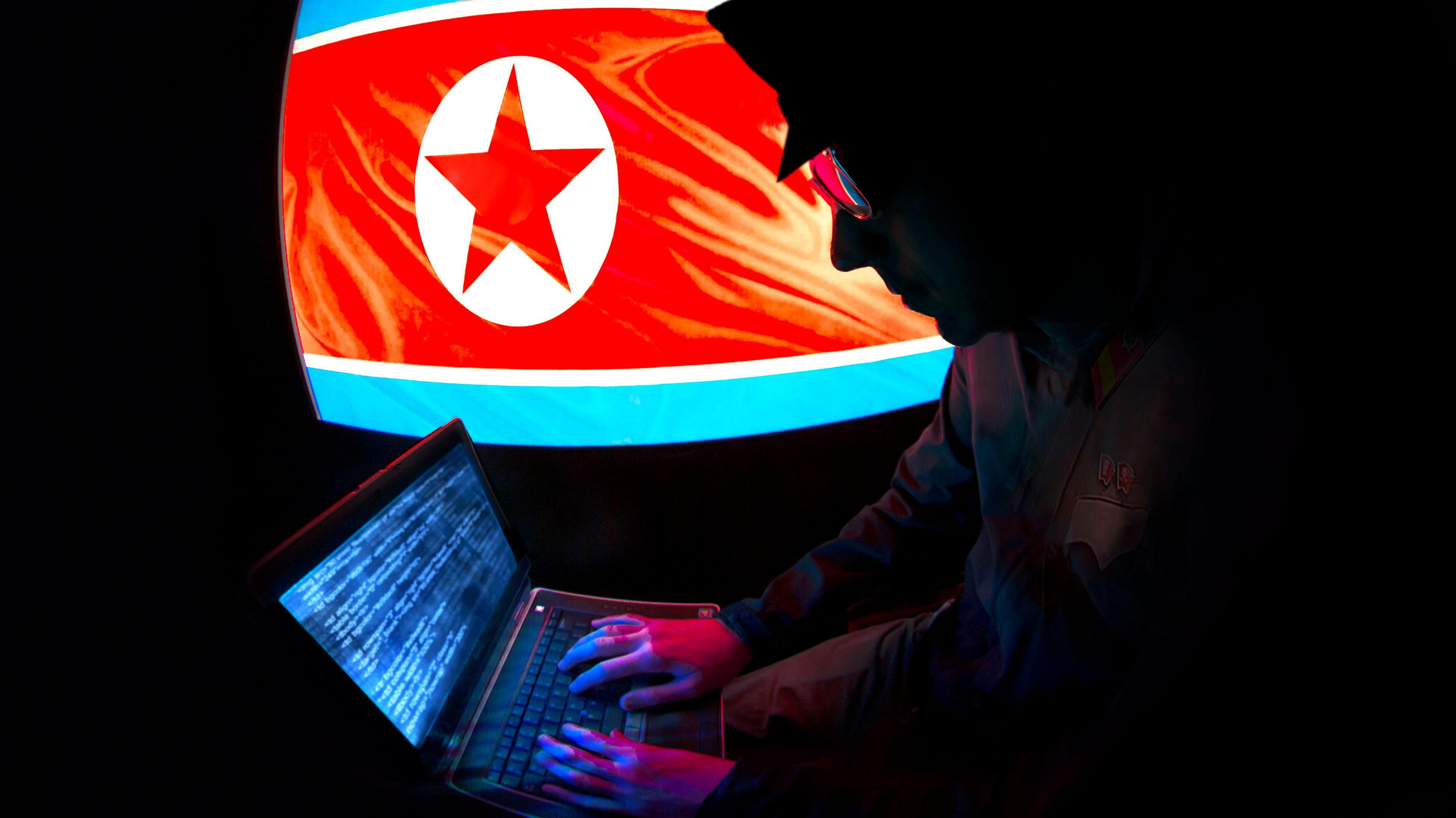 North Korean hacker silhouette with North Korean Flag.