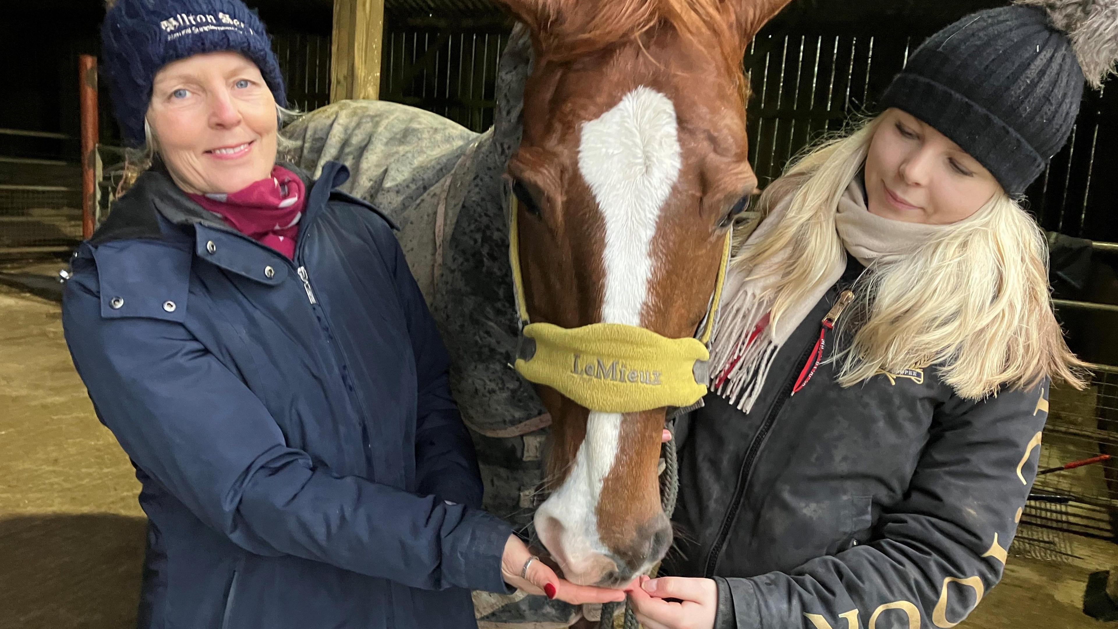 Mum and daughter with horse