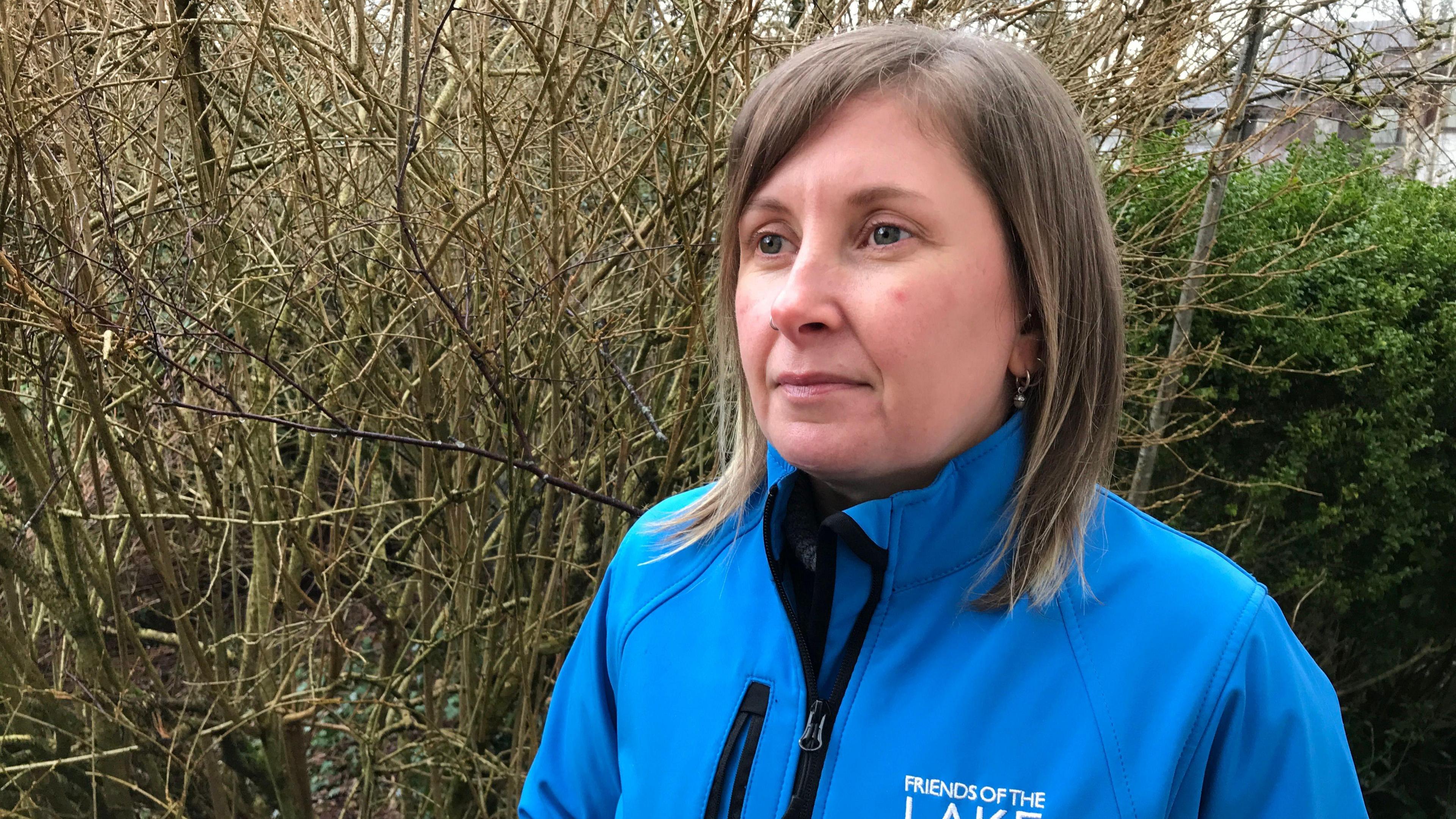 Spokeswoman Lorrayne Wall wearing a bright blue jacket showing a Friends of the Lake District logo