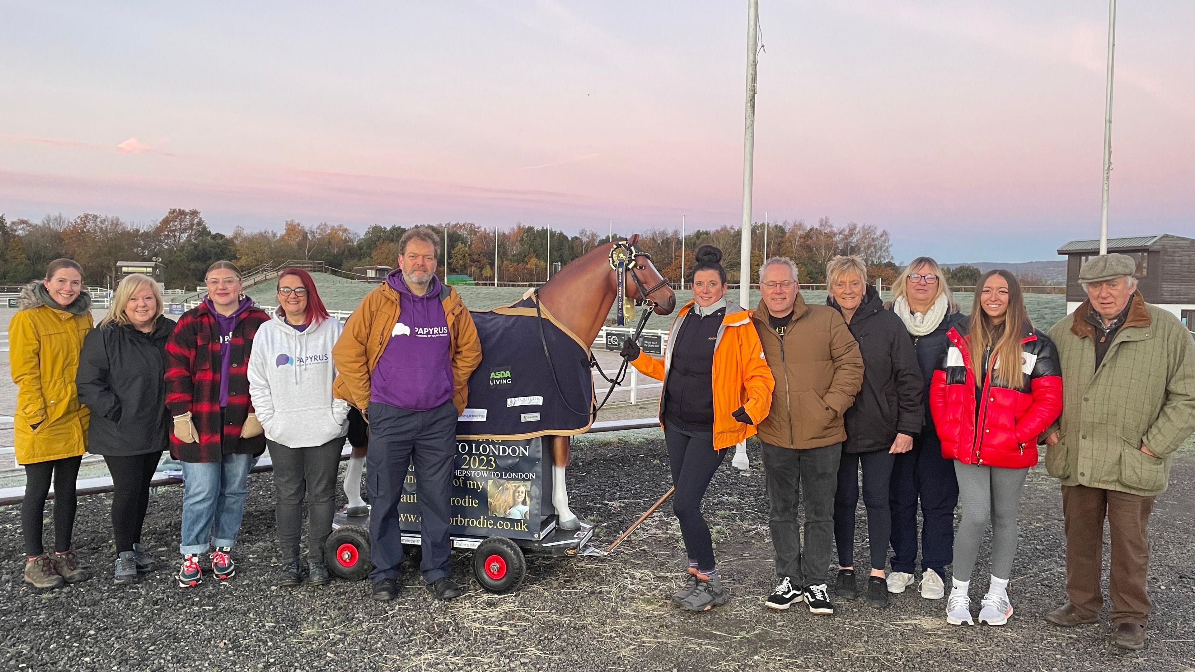 Emma Webb with her horse statue and a group of supporters about to set off