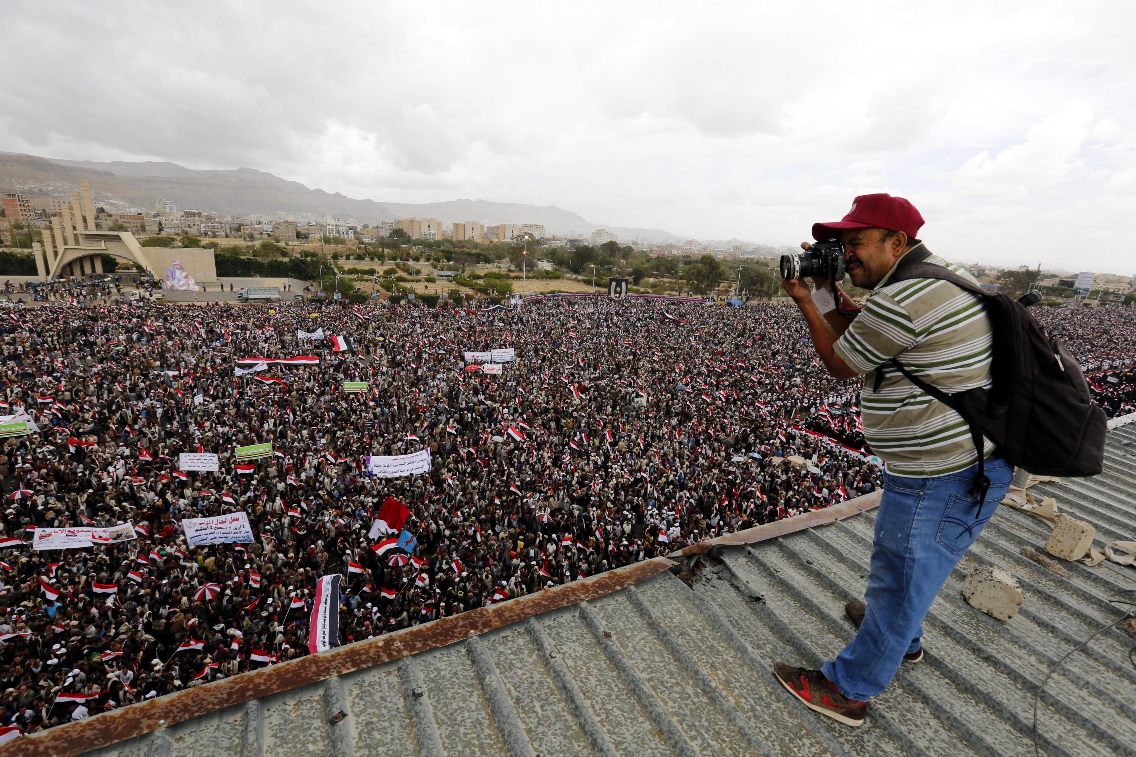 A Yemeni photographer takes photos of a rally in Sanaa