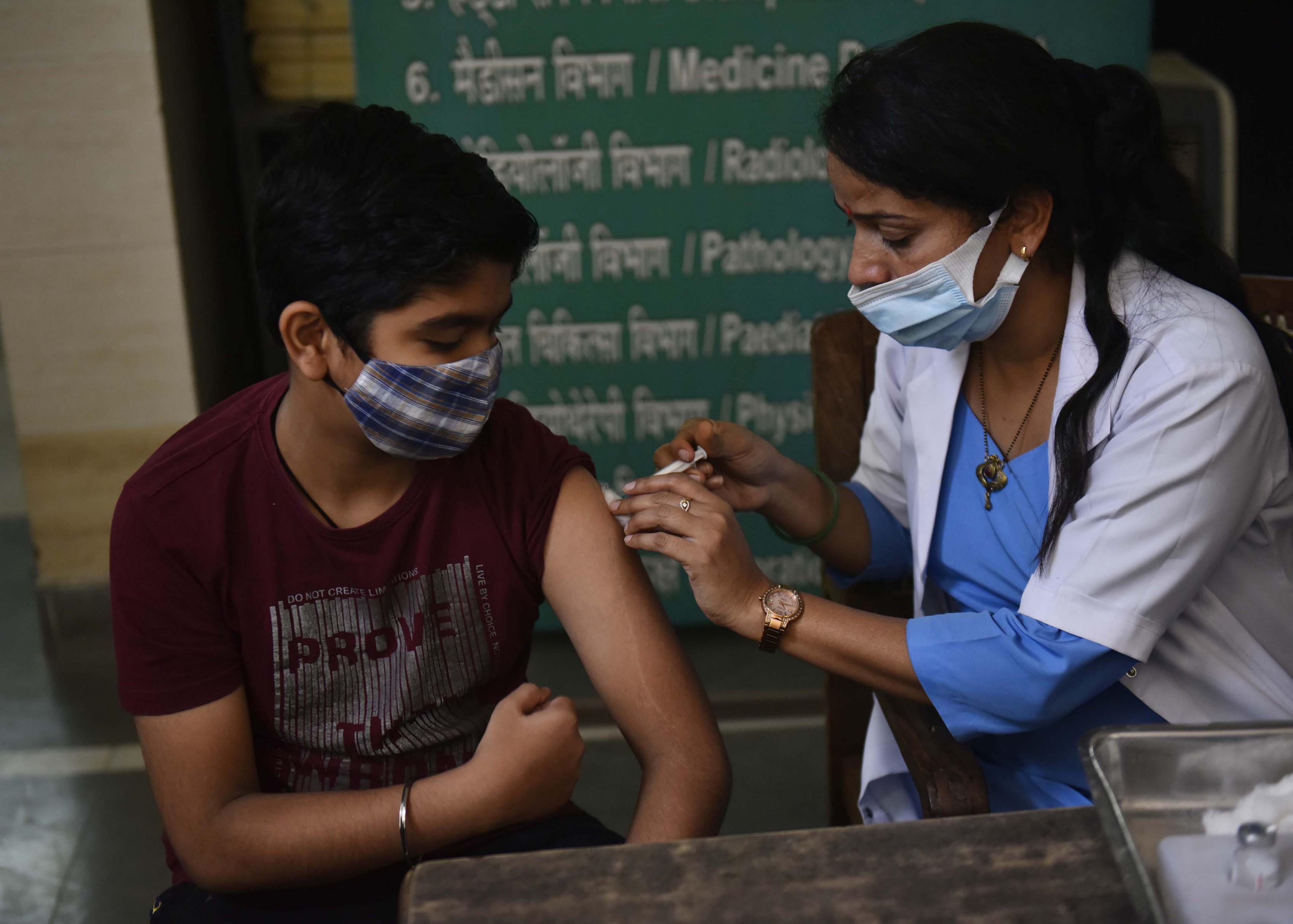 A child aged 12-14 receiving a covid 19 vaccine in India