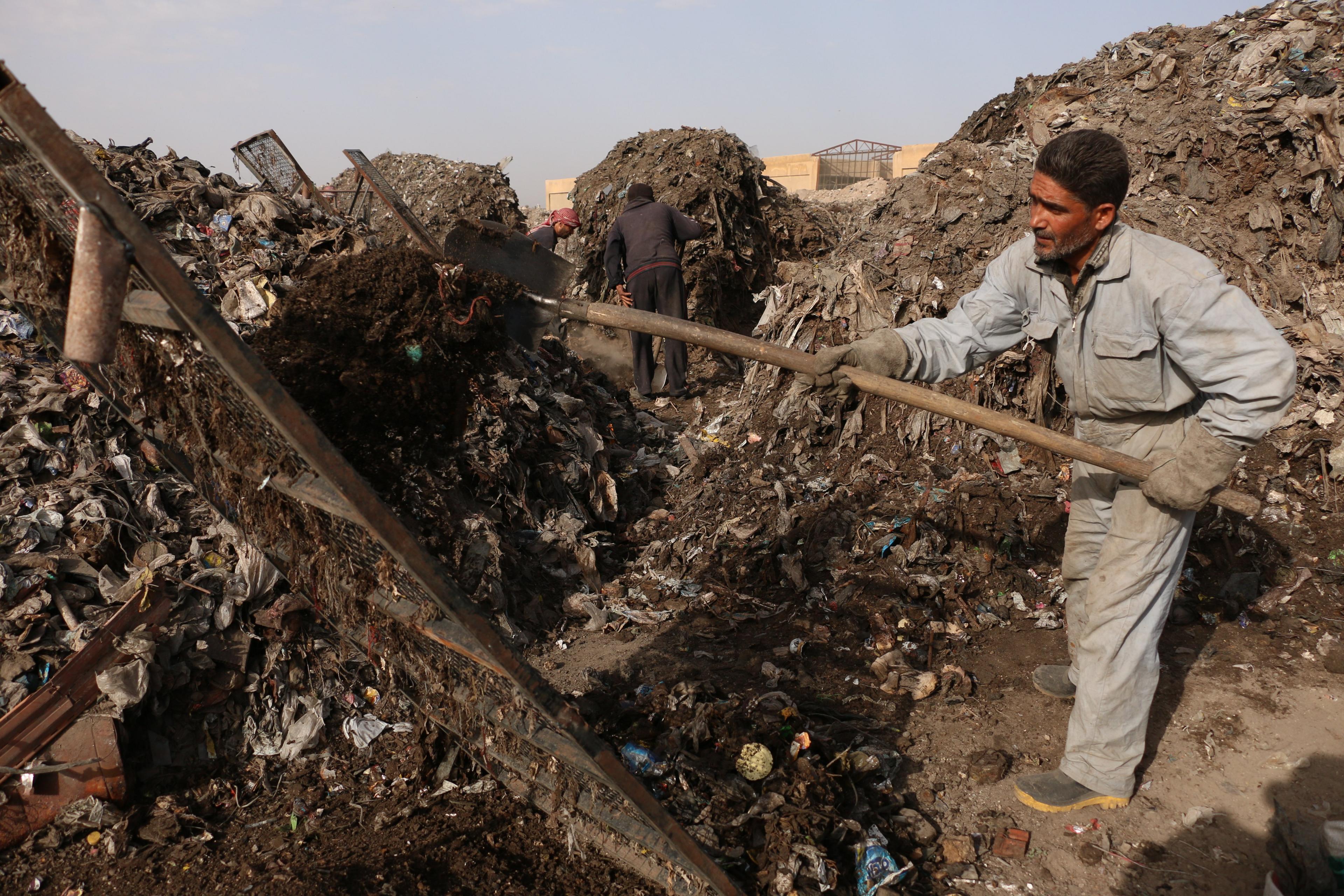 A resident works at a waste recycling centre