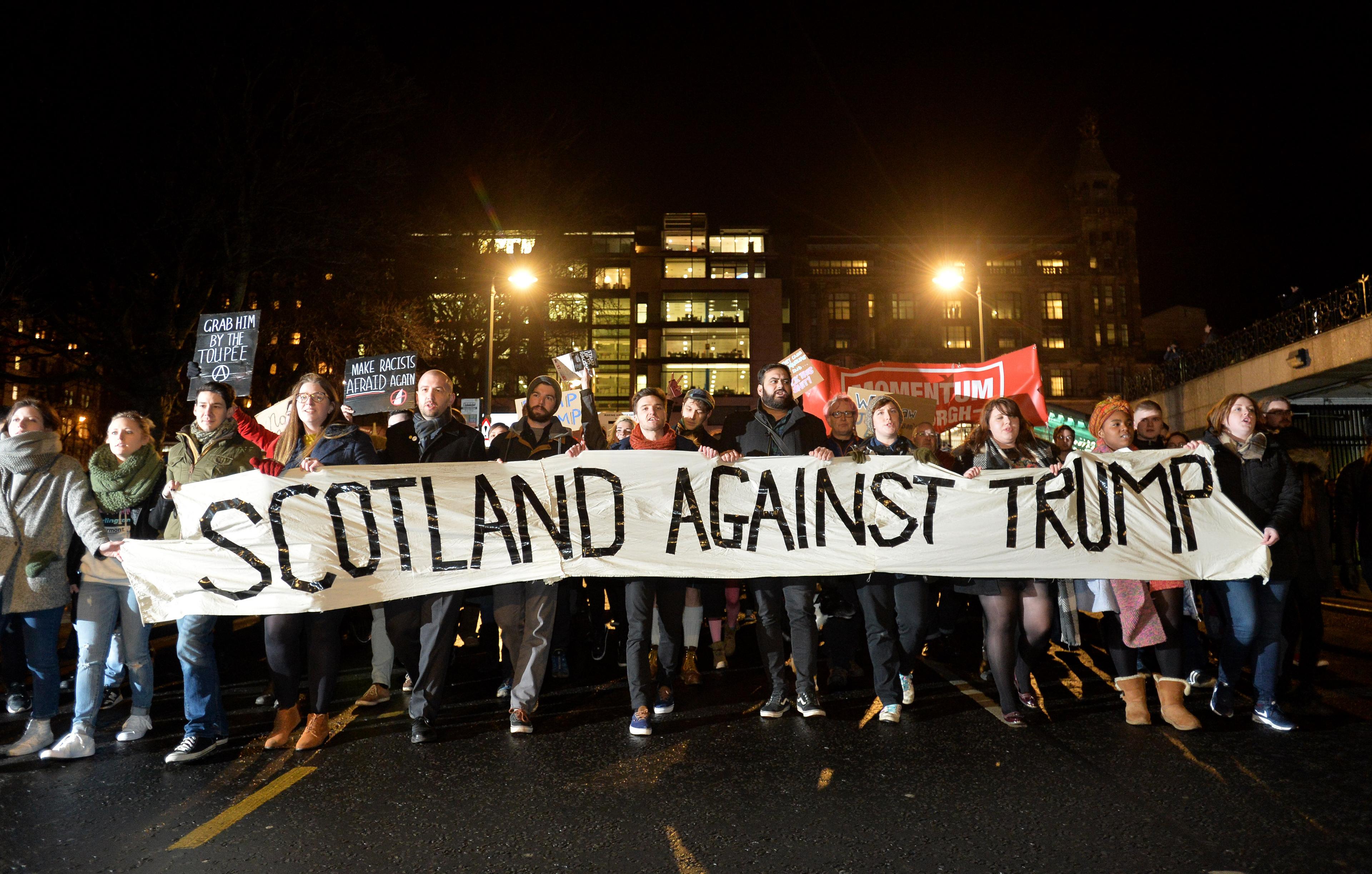 Demonstrators march from the Mound to the Scottish Parliament to protest against President Trump"s Muslim travel ban to the USA on January 30, 2017 in Edinburgh, Scotlan