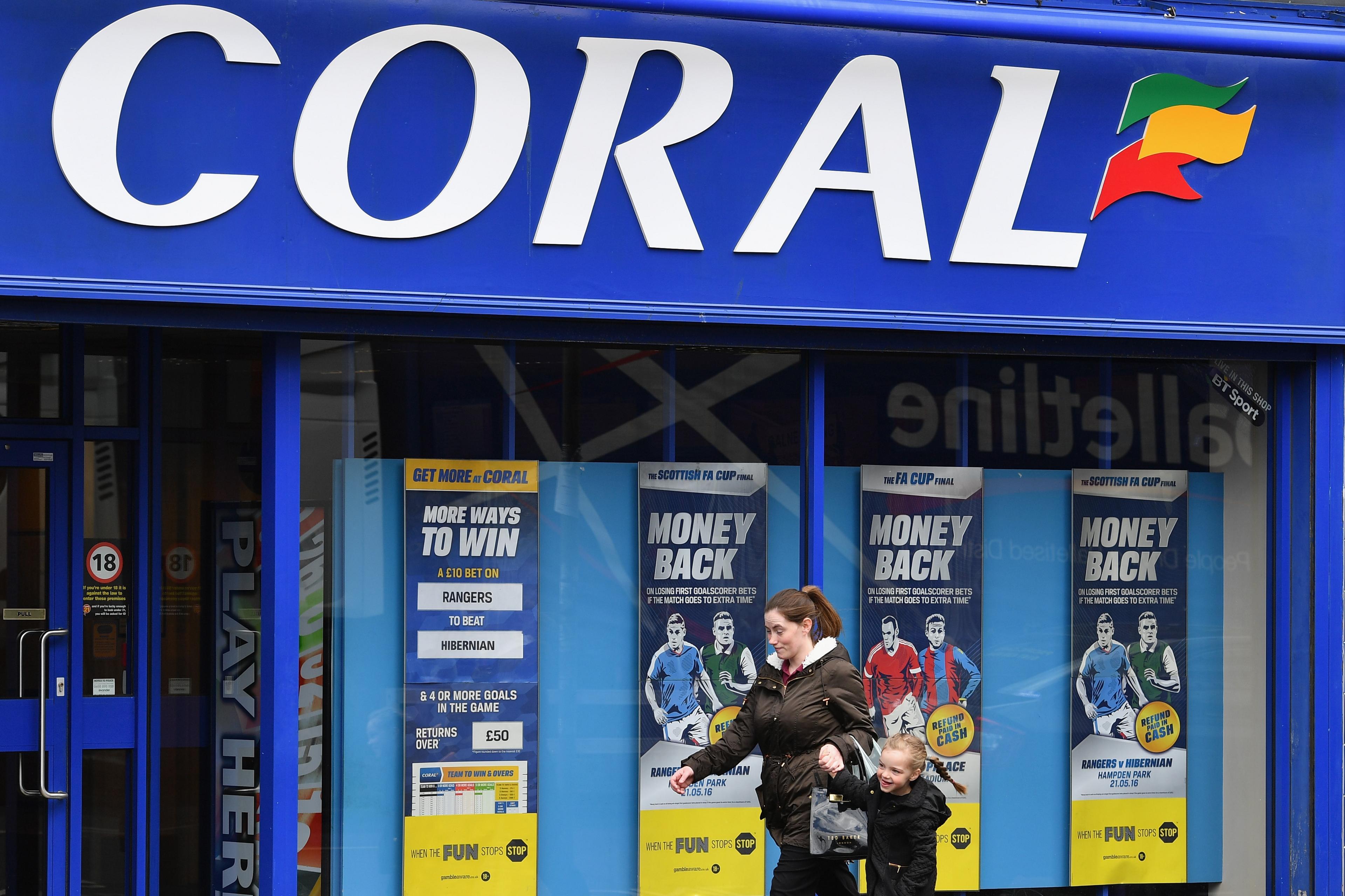 Woman walking past Coral branch